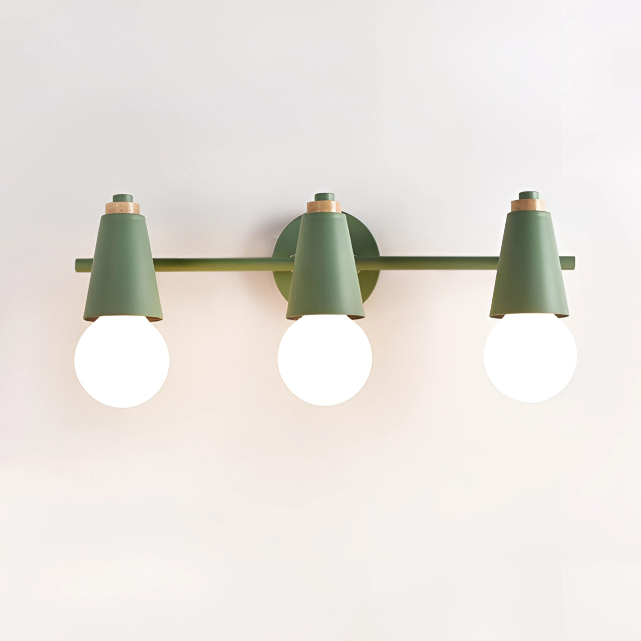 Modern Scandinavian green triple pendant light fixture with three energy-efficient lights, hanging from the ceiling over a table.