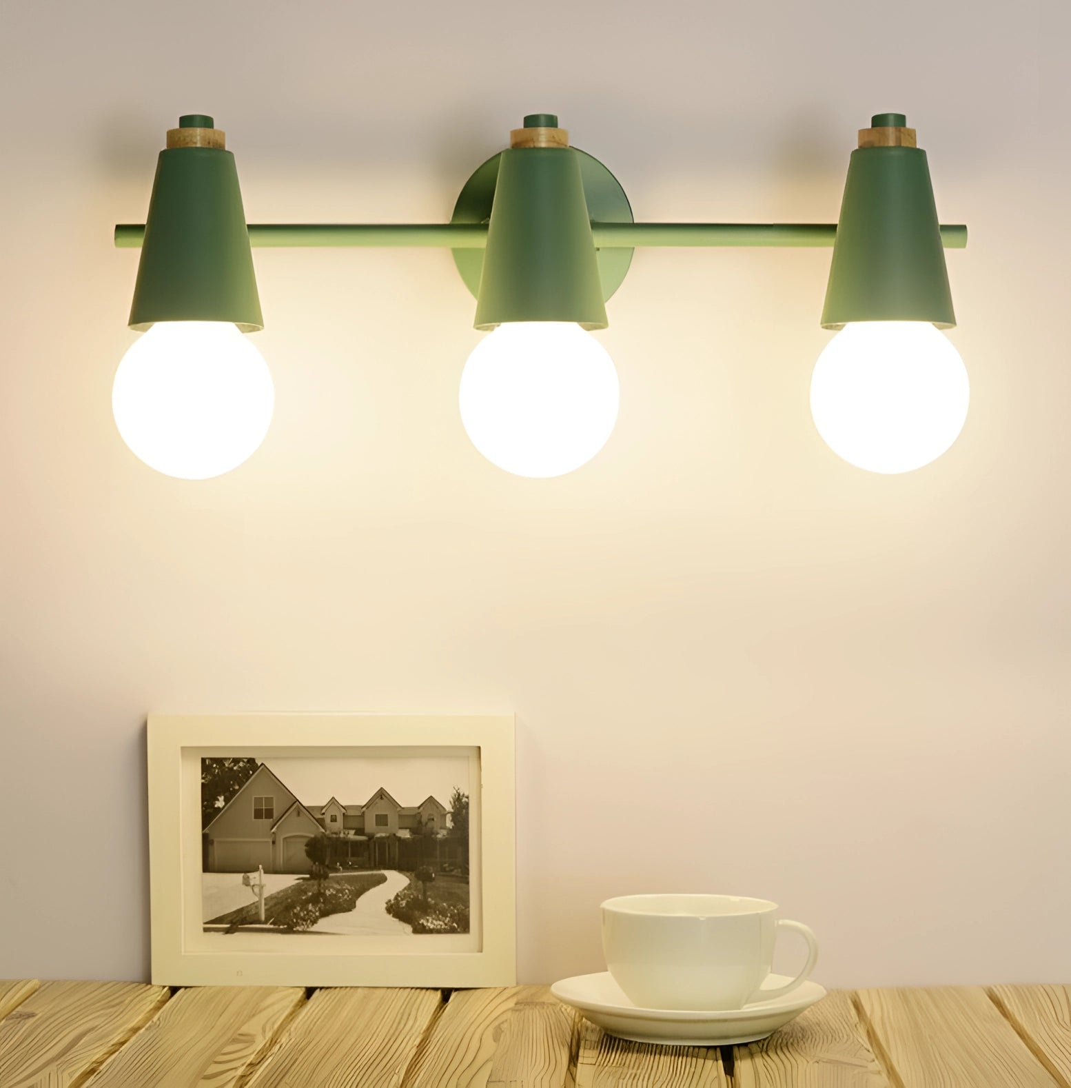Modern Scandinavian green triple pendant light with energy-efficient features, white shades, wooden accents, and sleek lines, designed for interior spaces and ceiling mounting.