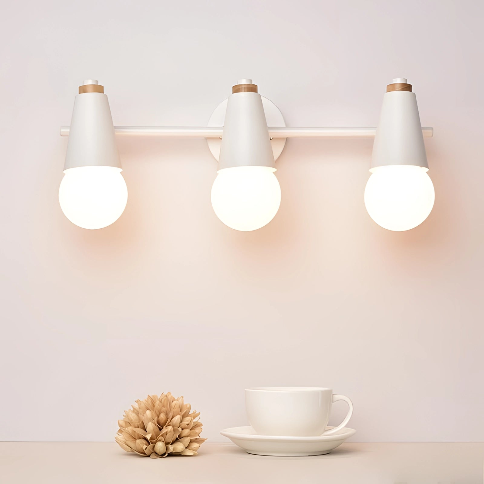 Modern green triple pendant light fixture illuminating a table set with white dishware and drinkware, showcasing Scandinavian design and energy-efficient lighting.