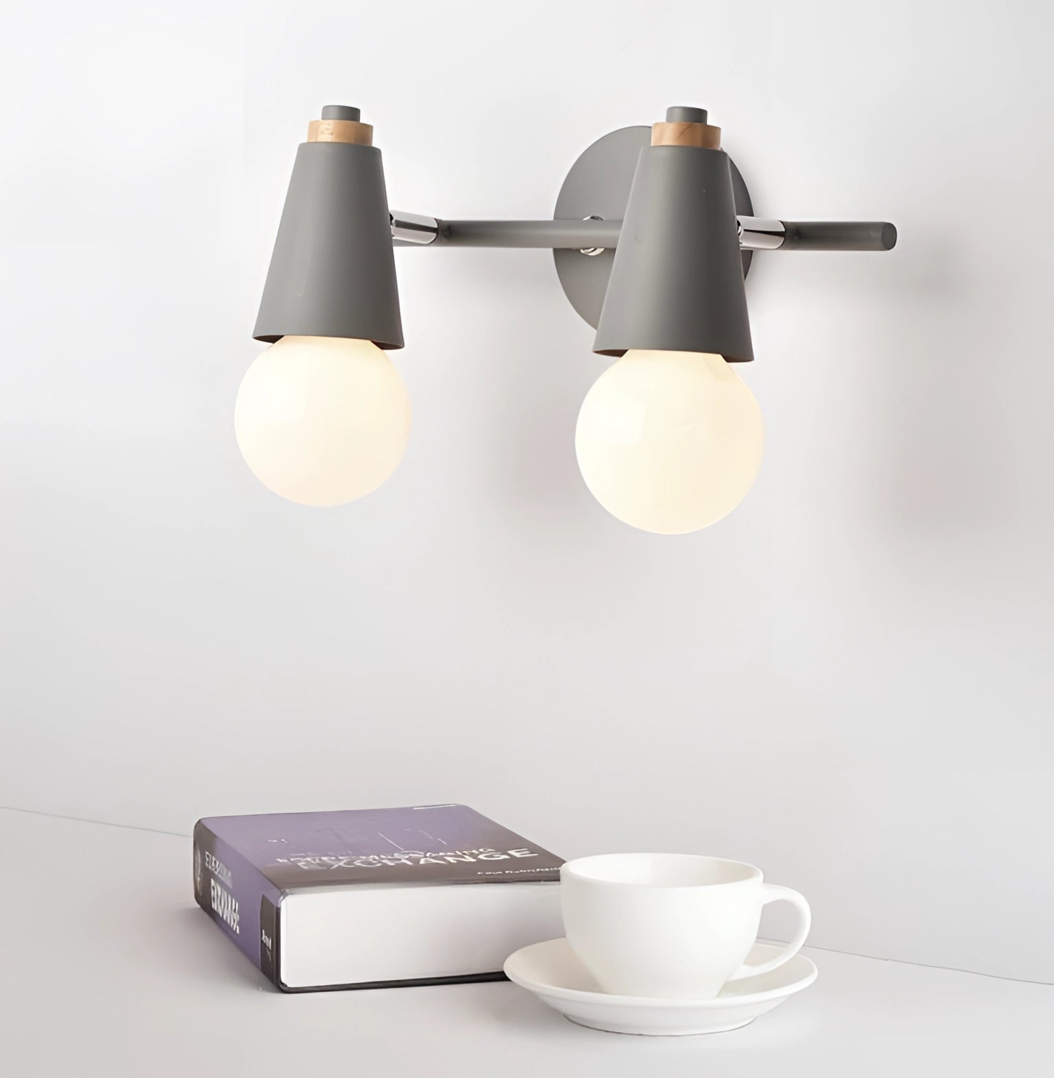 Modern Green Triple Pendant Lamp in Scandinavian Design Hanging over a White Table with Coffee Cups and Tableware in a Minimalist Interior Setting.