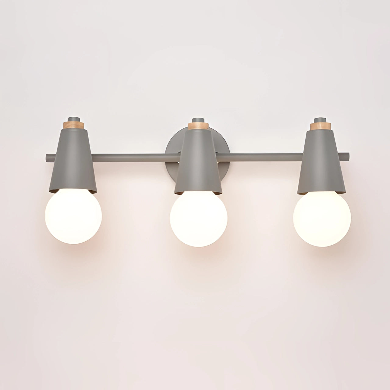 Modern energy-efficient Scandinavian green triple pendant light with gray lampshades, styled above a table.