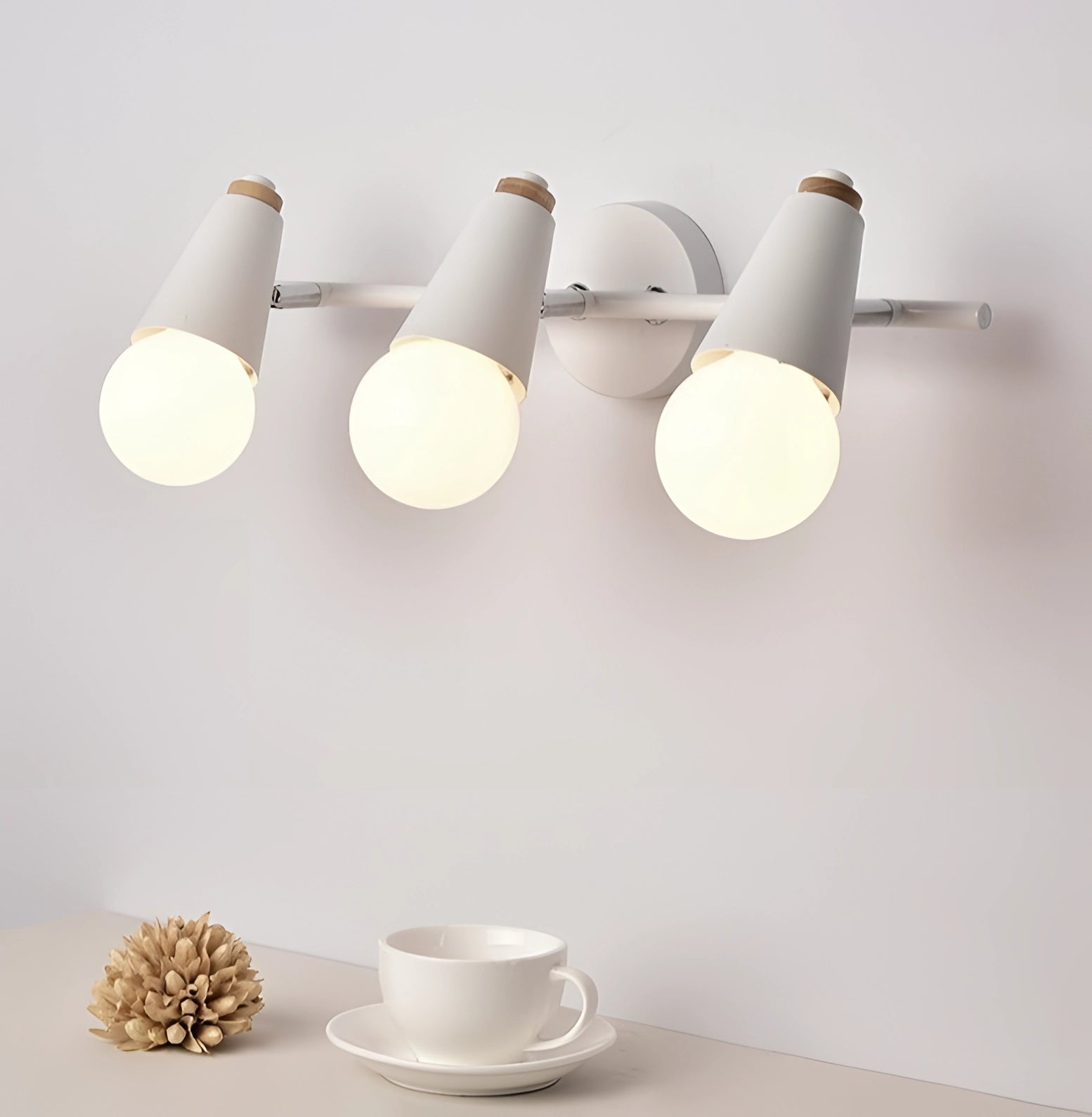 Modern green triple pendant light fixture with energy-efficient Scandinavian design, featuring three dome-shaped lamps hanging from a wooden ceiling mount.