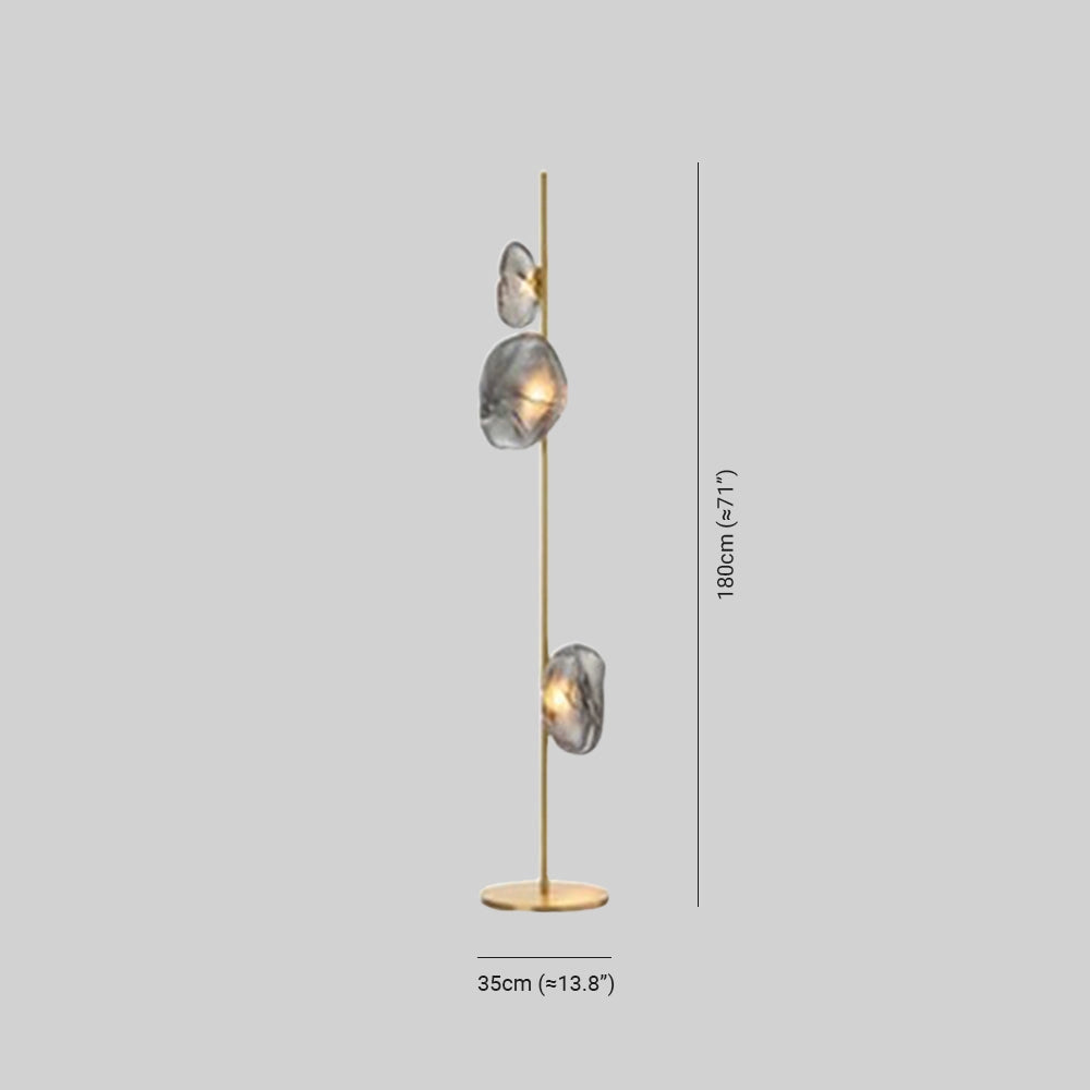 Industrial metallic pebble floor lamp with a sculptural design, featuring a circular brass light fixture resembling a cluster of pebbles.