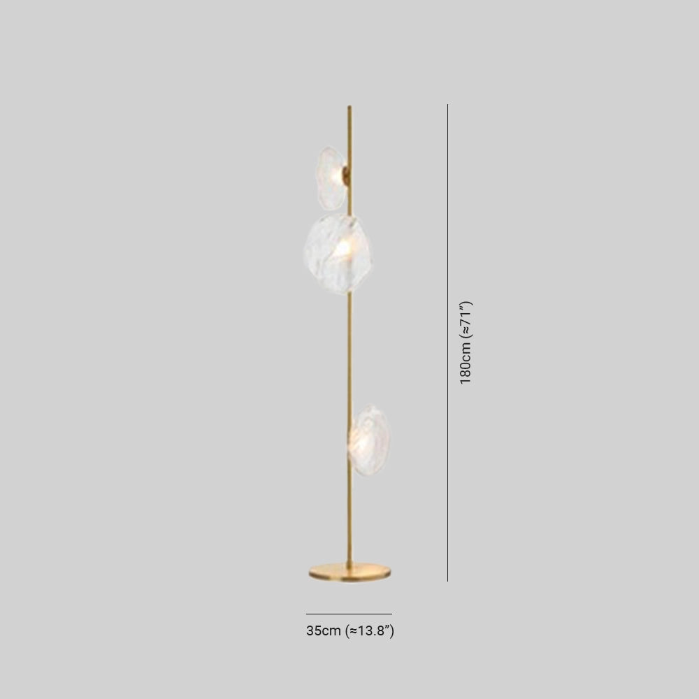 Industrial metallic pebble floor lamp with a sculptural design, featuring a sleek metal finish and a unique circular shape, creating an artistic and modern lighting fixture.