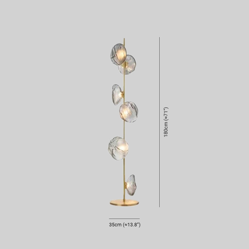 Industrial metallic pebble floor lamp featuring a sculptural design with a circular form, crafted from metal and brass, showcasing an artistic and contemporary look with a visible light bulb.