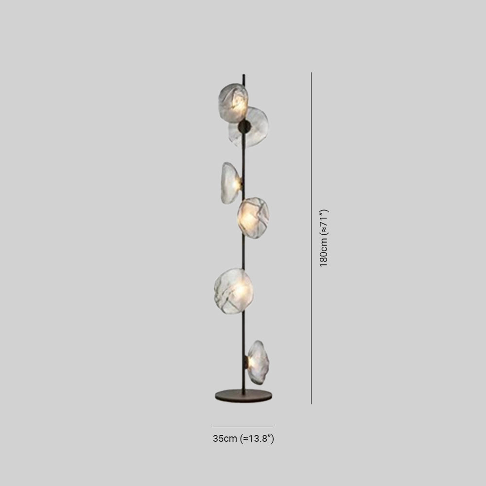 Industrial metallic pebble floor lamp with a sculptural design, featuring metal and glass elements, resembling a piece of modern art or jewelry with twig-like structural details.