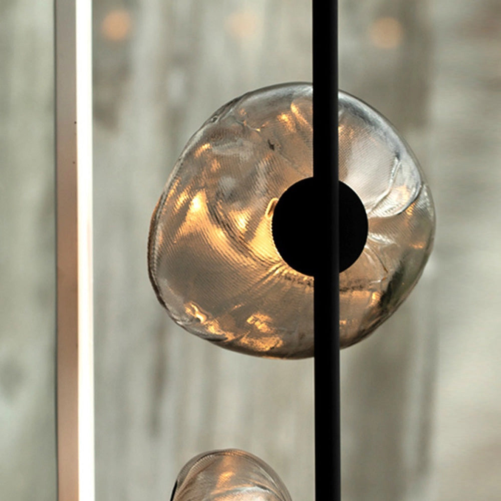 Industrial Metallic Pebble Floor Lamp with sculptural design featuring metallic and glass elements, showcasing a unique, artistic lighting fixture.
