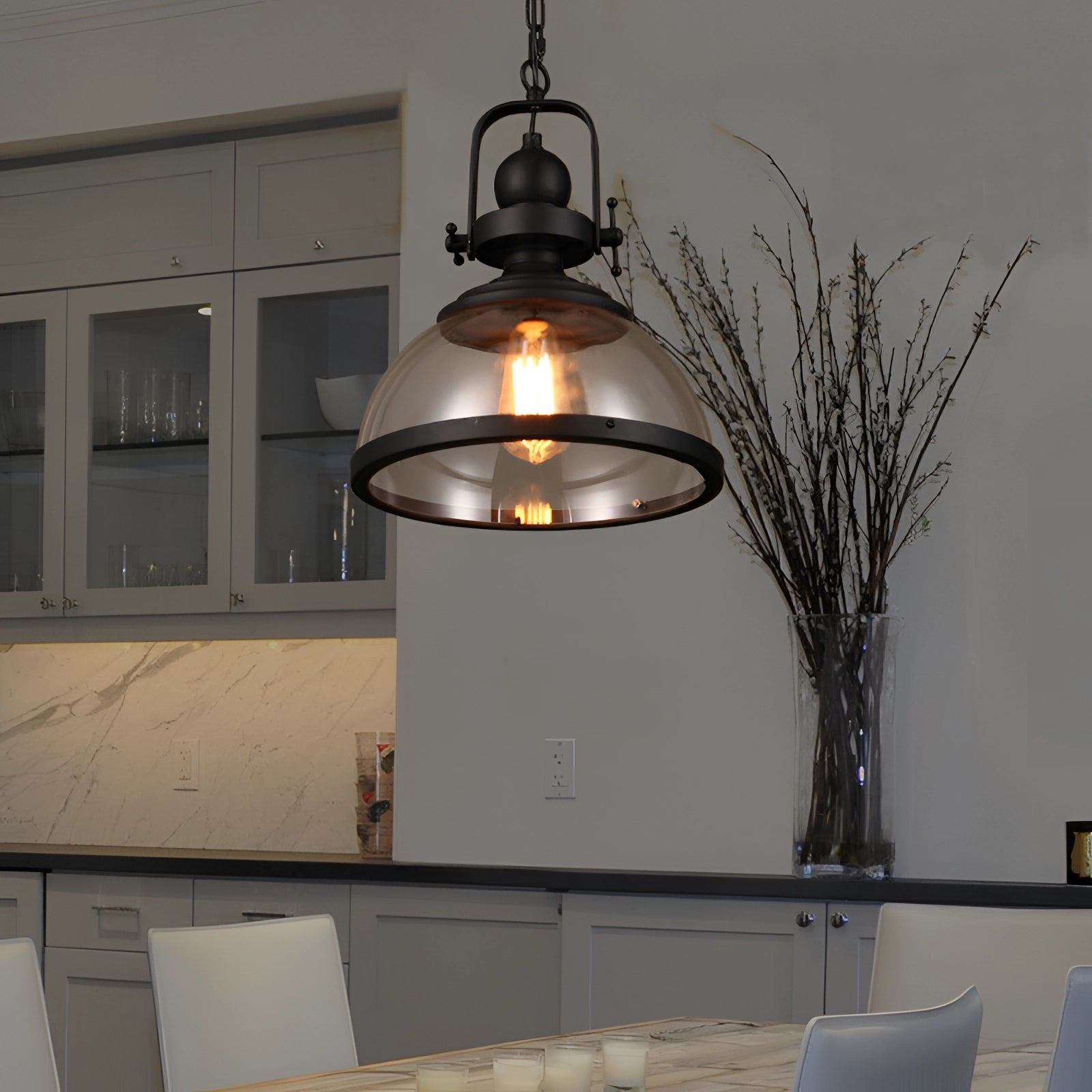 Industrial pendant lights with rustic Edison bulb chandelier decor hanging in an interior setting featuring large windows, wooden accents, and a touch of greenery.