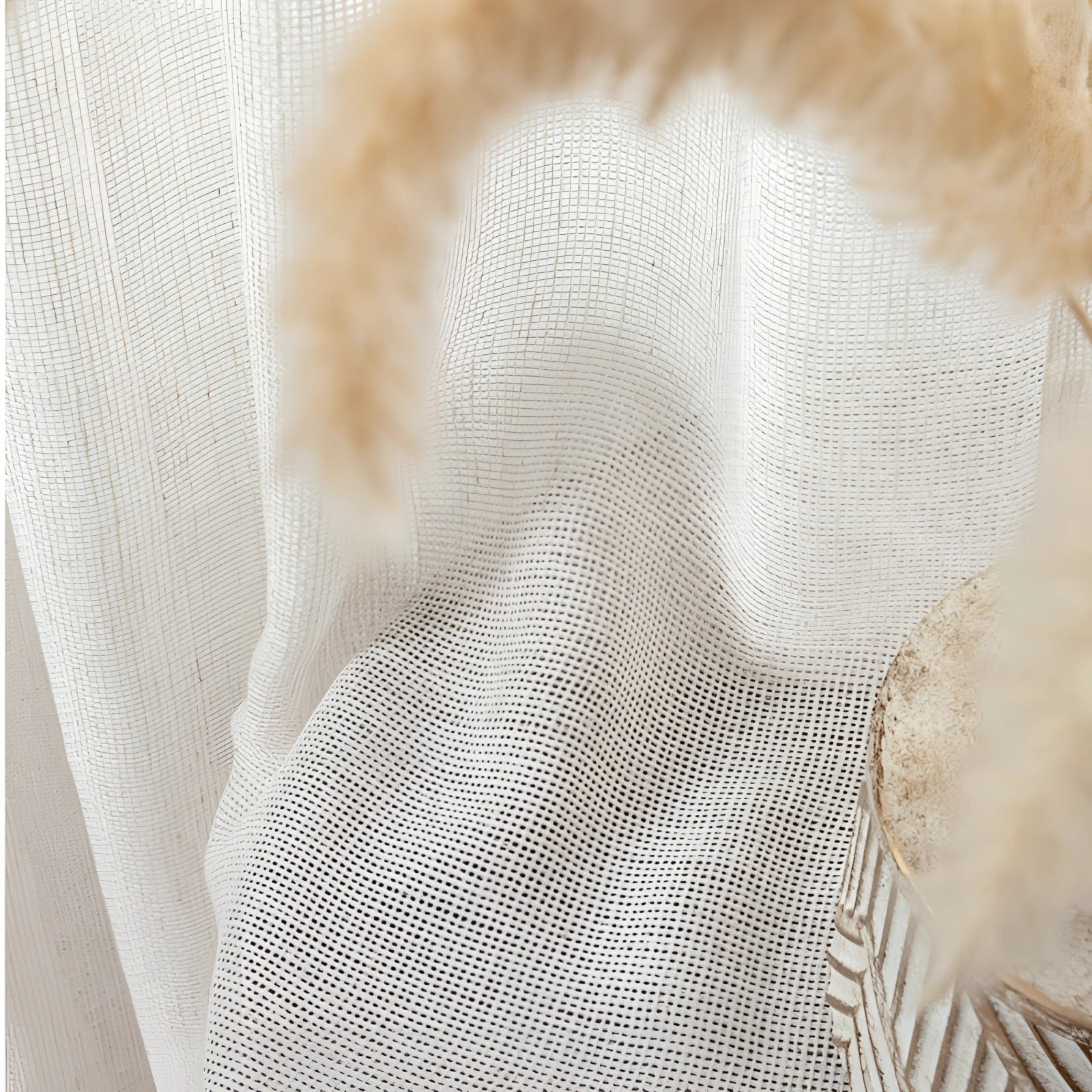 Ivory sheer curtains elegantly hanging in a living room, featuring a linen texture and delicate pattern, with natural light filtering through, creating a soft and airy atmosphere.