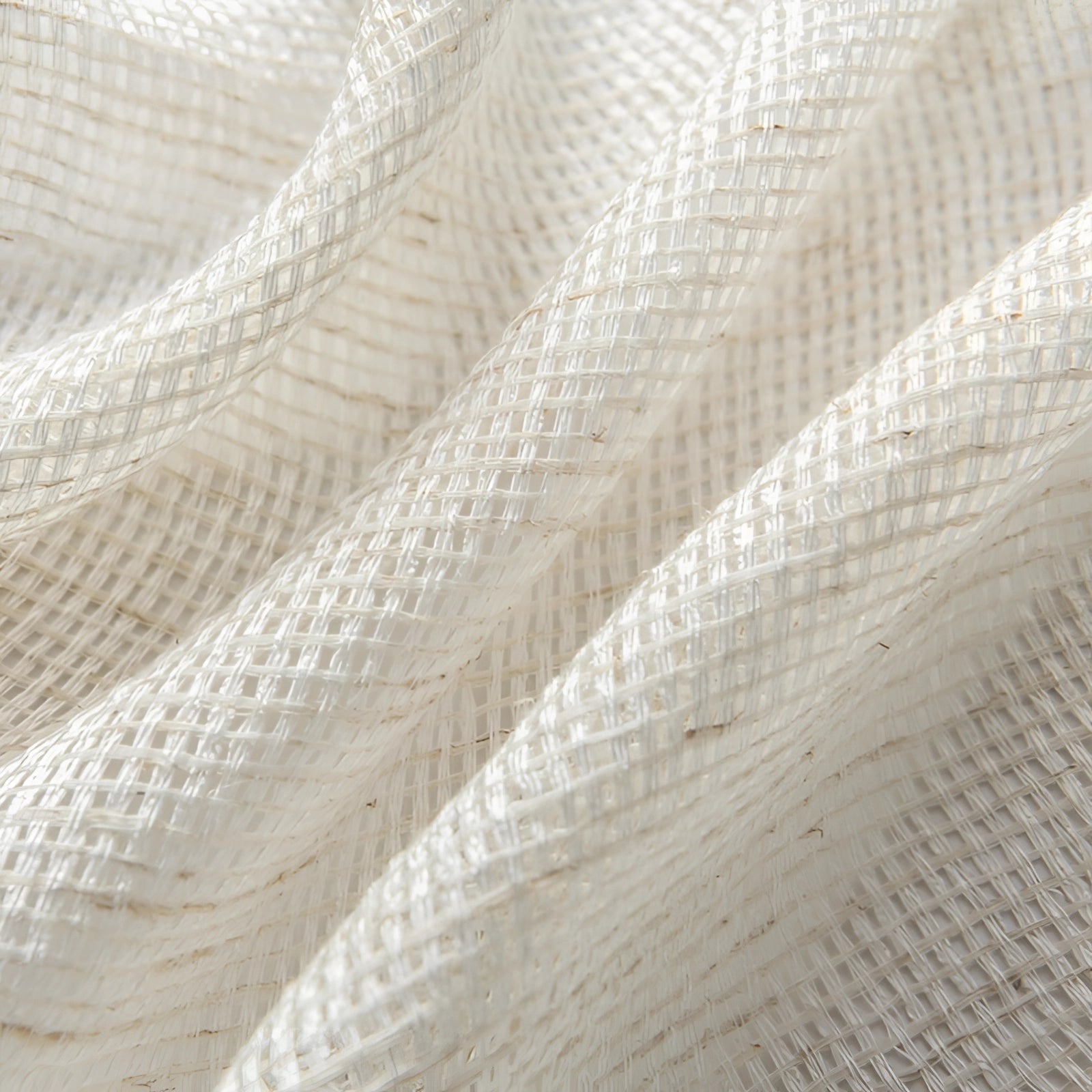 Ivory sheer curtains made of elegant linen fabric, displayed in a living room setting with a close-up view highlighting the subtle pattern and neutral tones of beige and khaki.