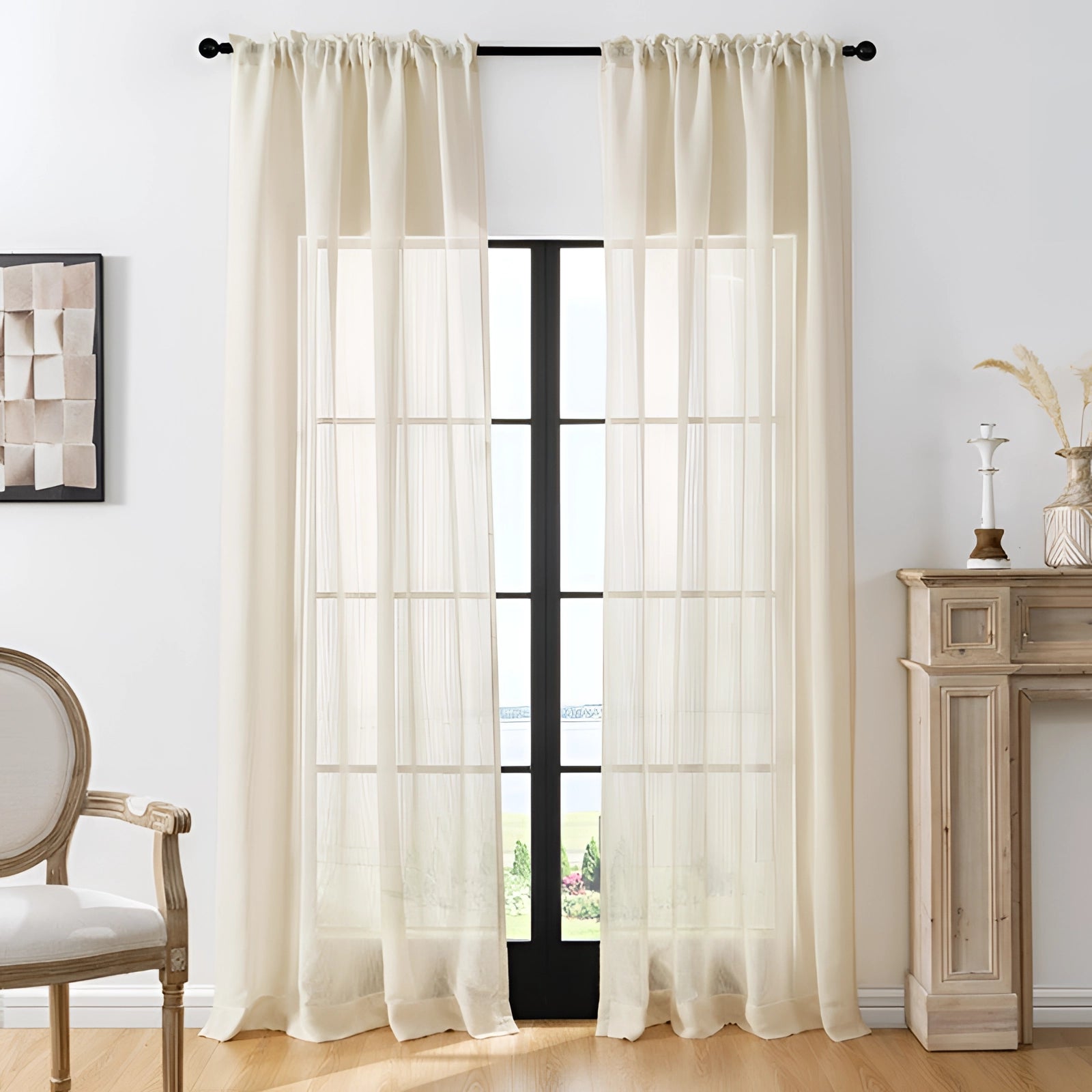 Ivory sheer curtains in a cream color elegantly draped over a rectangular window, complementing the interior design with their soft beige hue and adding a touch of sophistication to the living room decor.