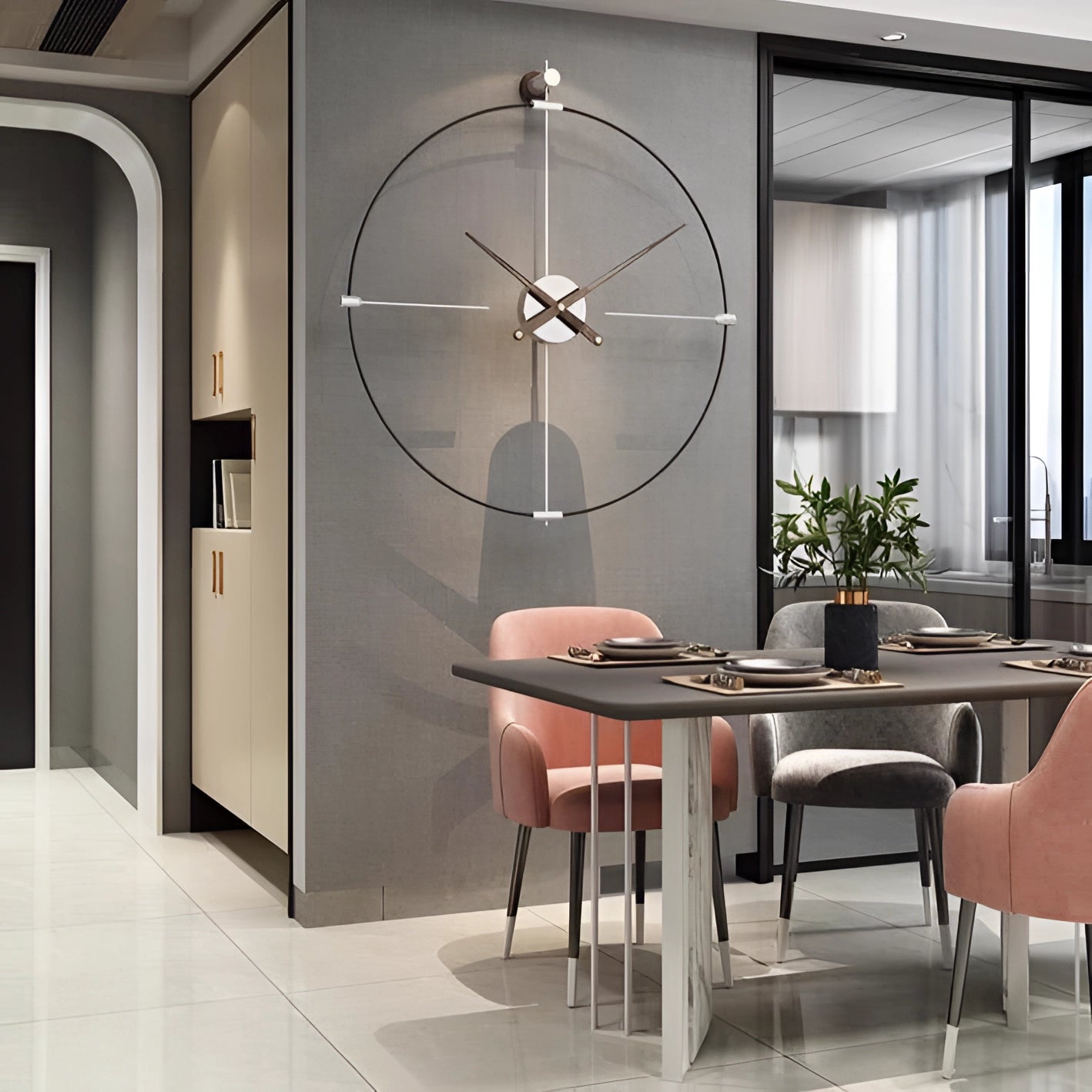 Large luxury metal wall clock with a modern minimalist design hanging on a wall in a well-decorated interior space featuring furniture like a table and chairs, a houseplant, wooden elements, and a large window, showcasing an elegant and contemporary decor theme.
