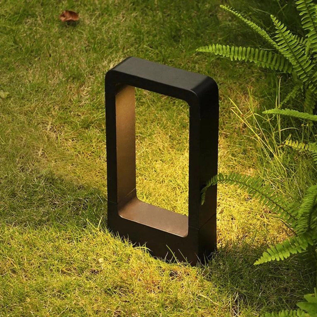 LED garden pathway lights illuminating a walkway surrounded by grass and plants, featuring a weather-resistant and energy-efficient design.