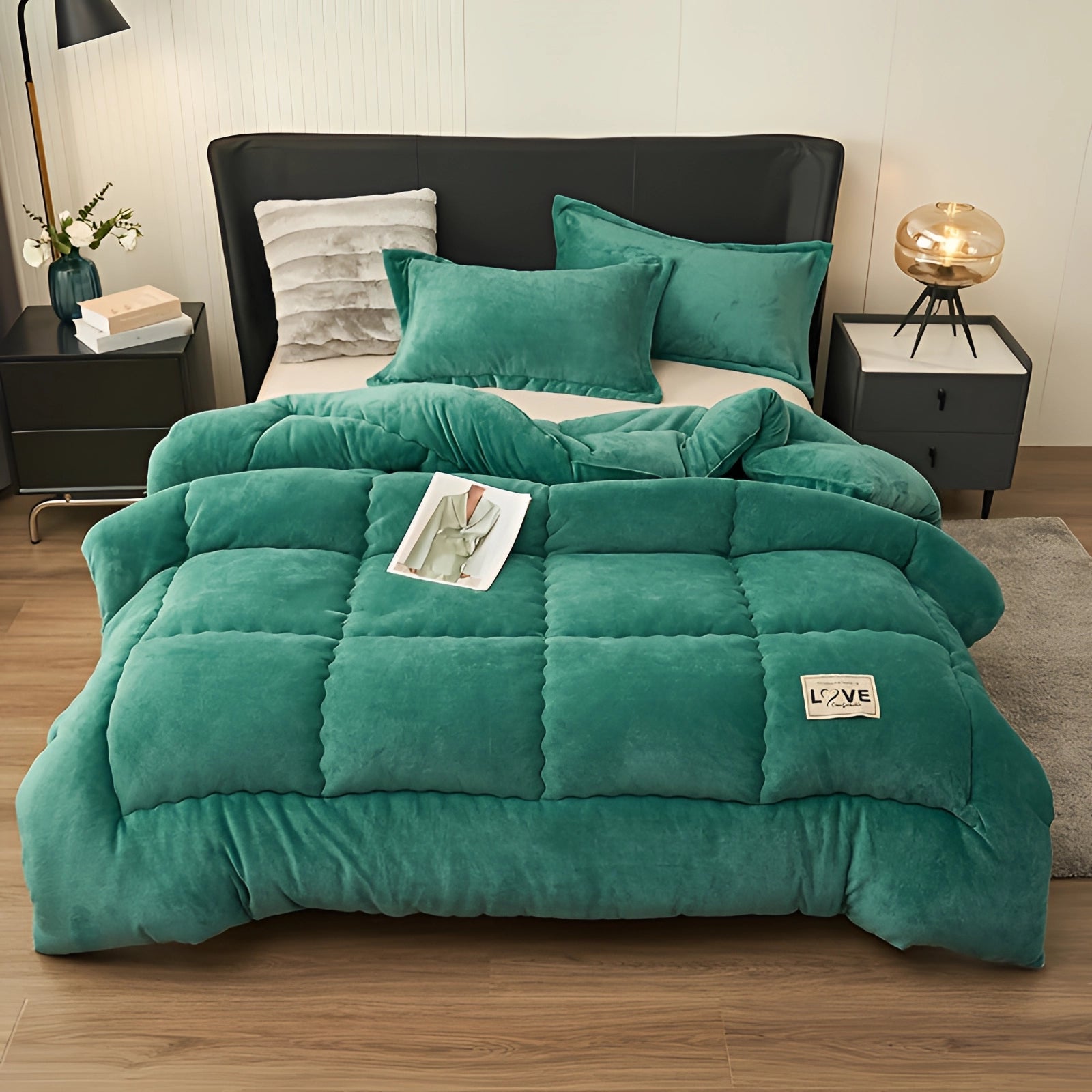 Luxurious green velvet comforter set with plush quilt and pillow, displayed on a wooden couch, suitable for winter.