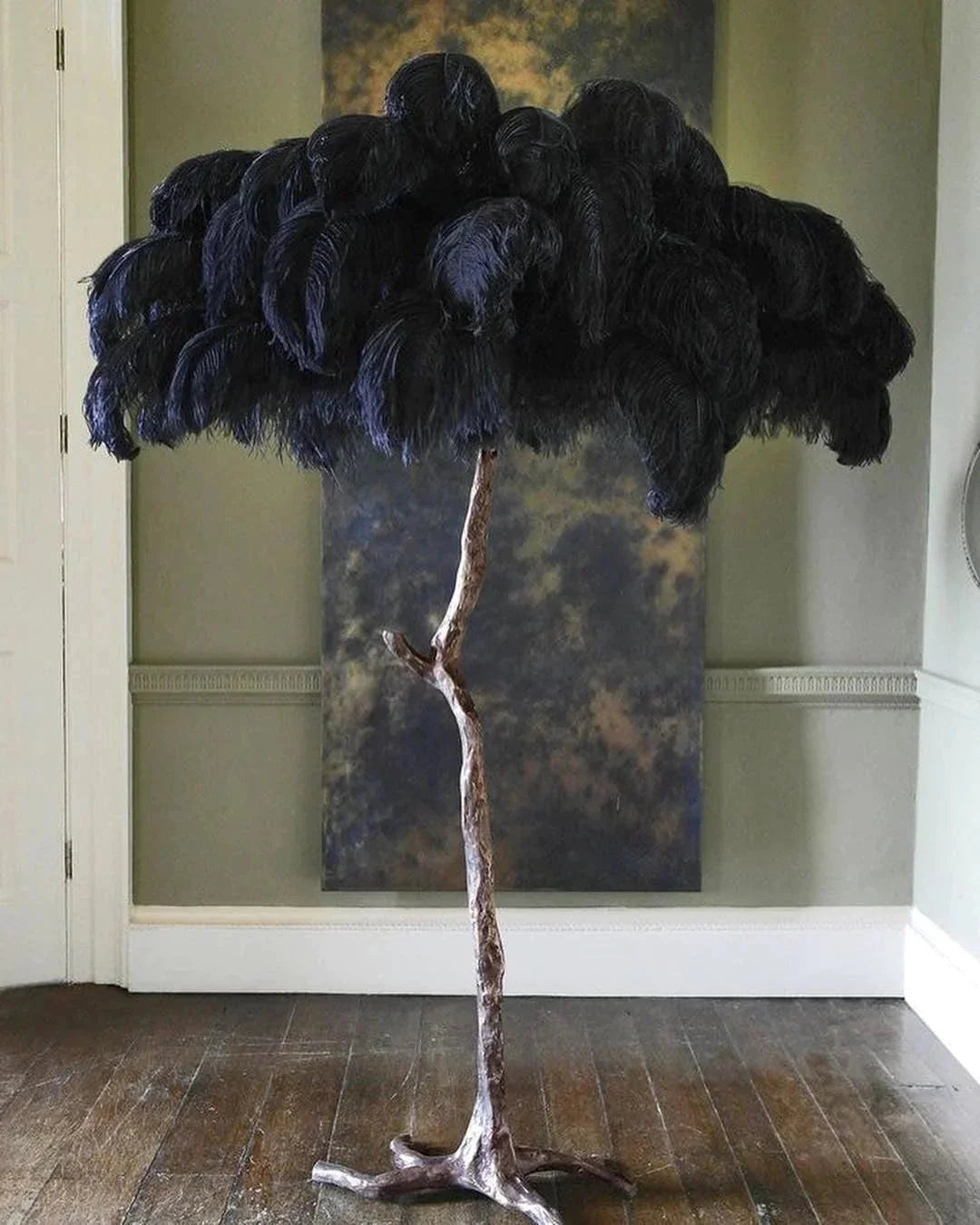A luxury feather floor lamp designed in the shape of a gold palm tree with black details, featuring art deco styling and natural materials.