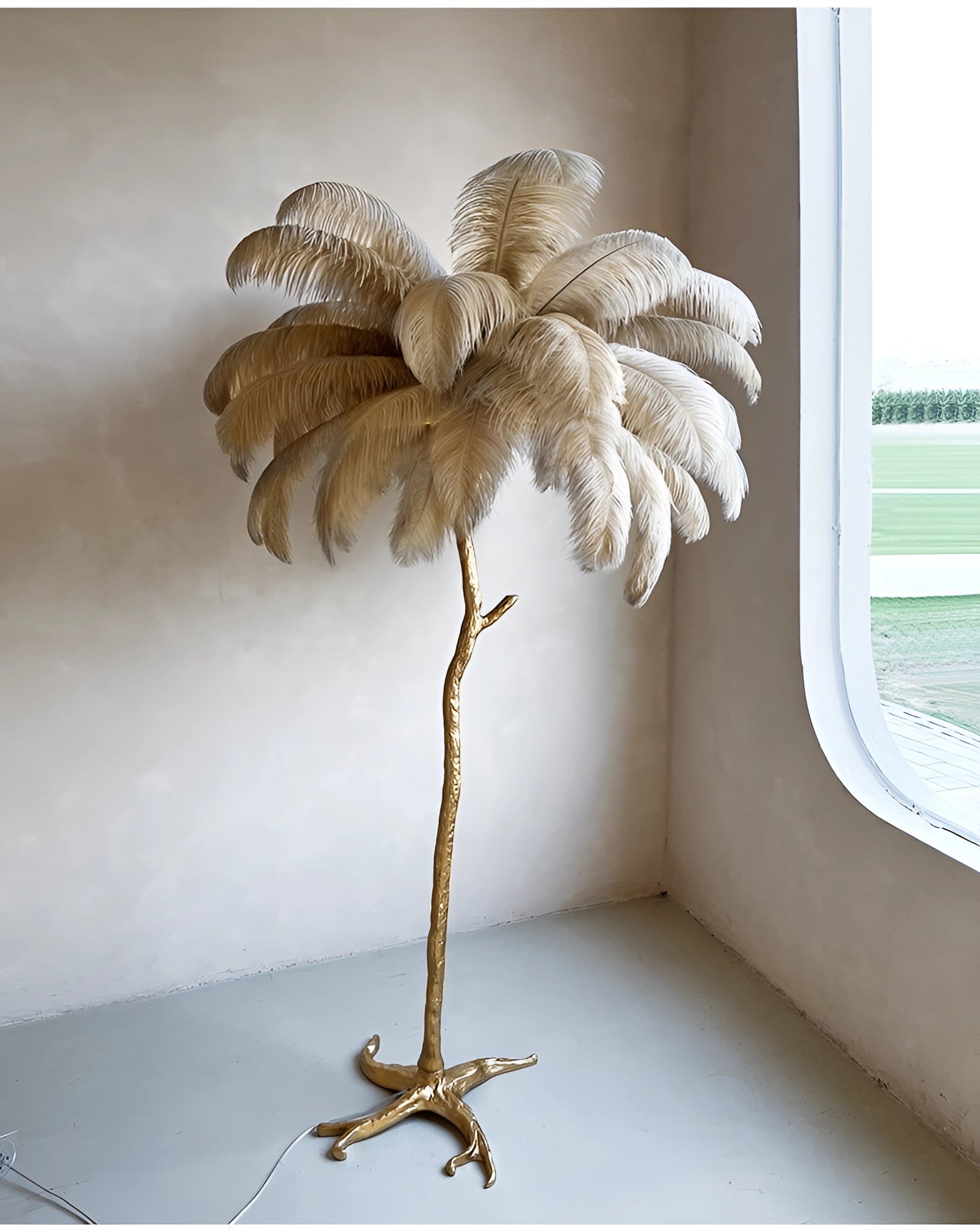 Luxury Feather Floor Lamp with Gold Palm Tree Design in an Art Deco Style, placed in an interior setting with picture frames, plants, and textiles.