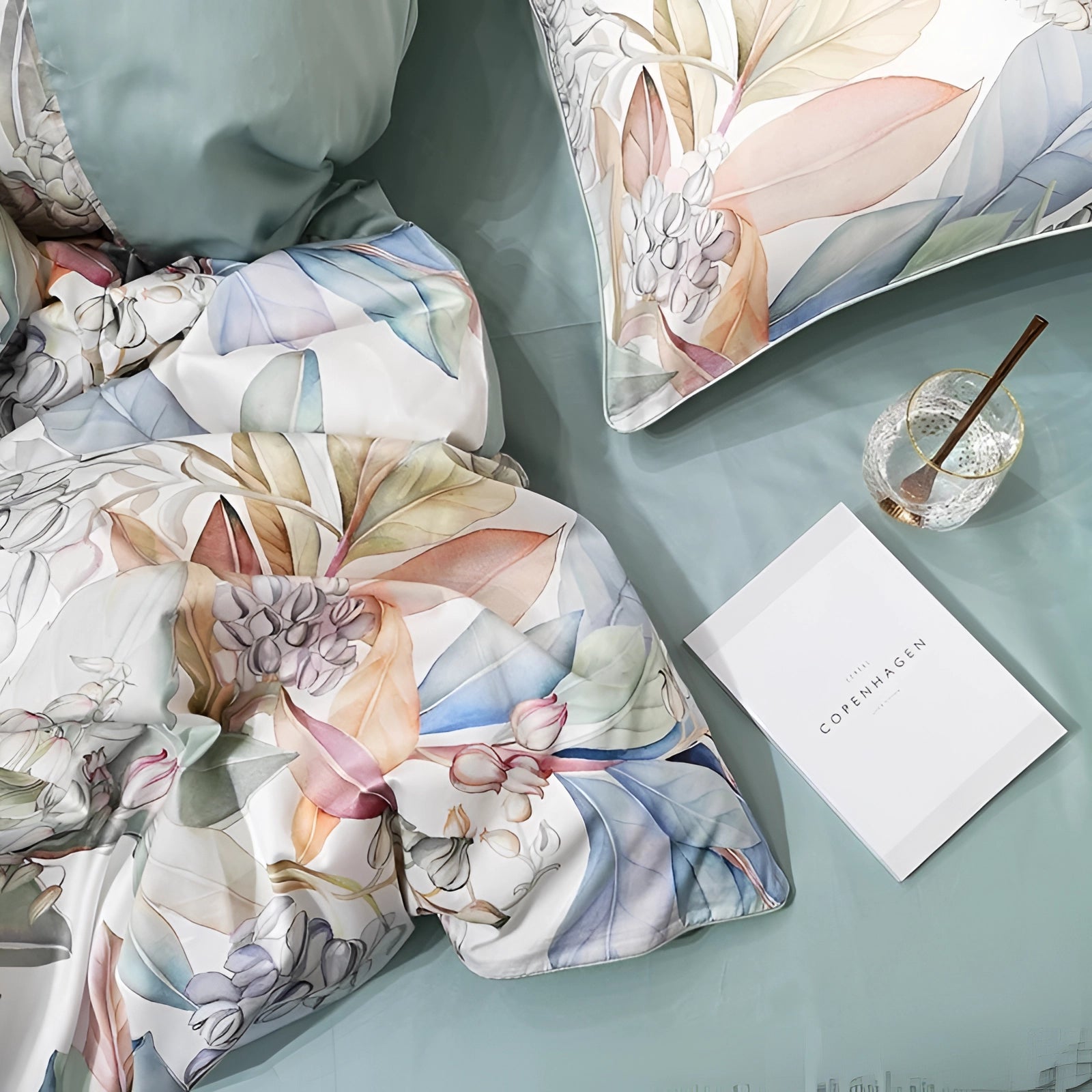 Luxury floral bedding set in pastel green, featuring a cotton duvet and pillow set adorned with delicate flower patterns.