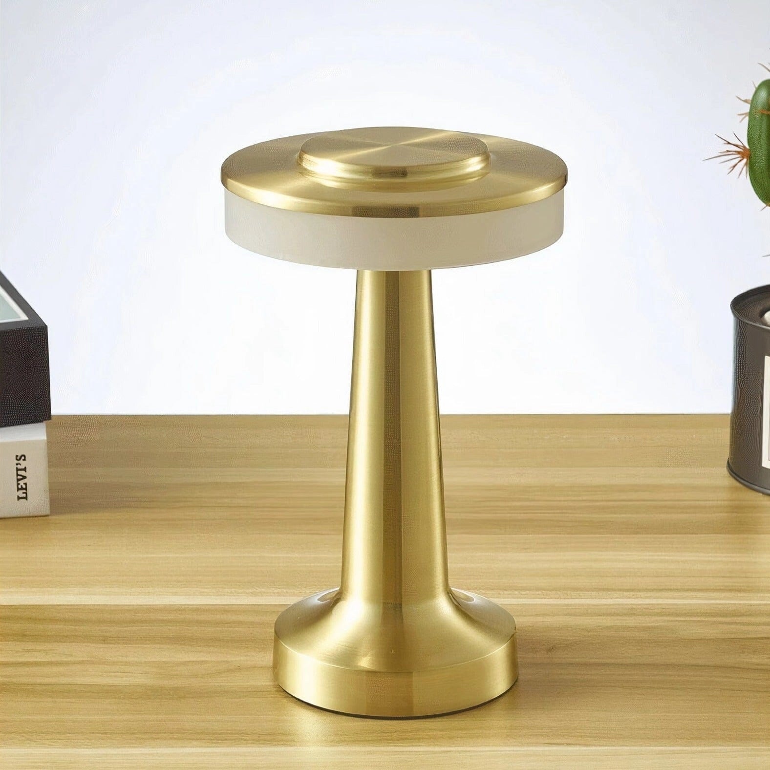 Luxury modern LED desk lamp with brass finish on a wooden table, ideal for bedside and office use.