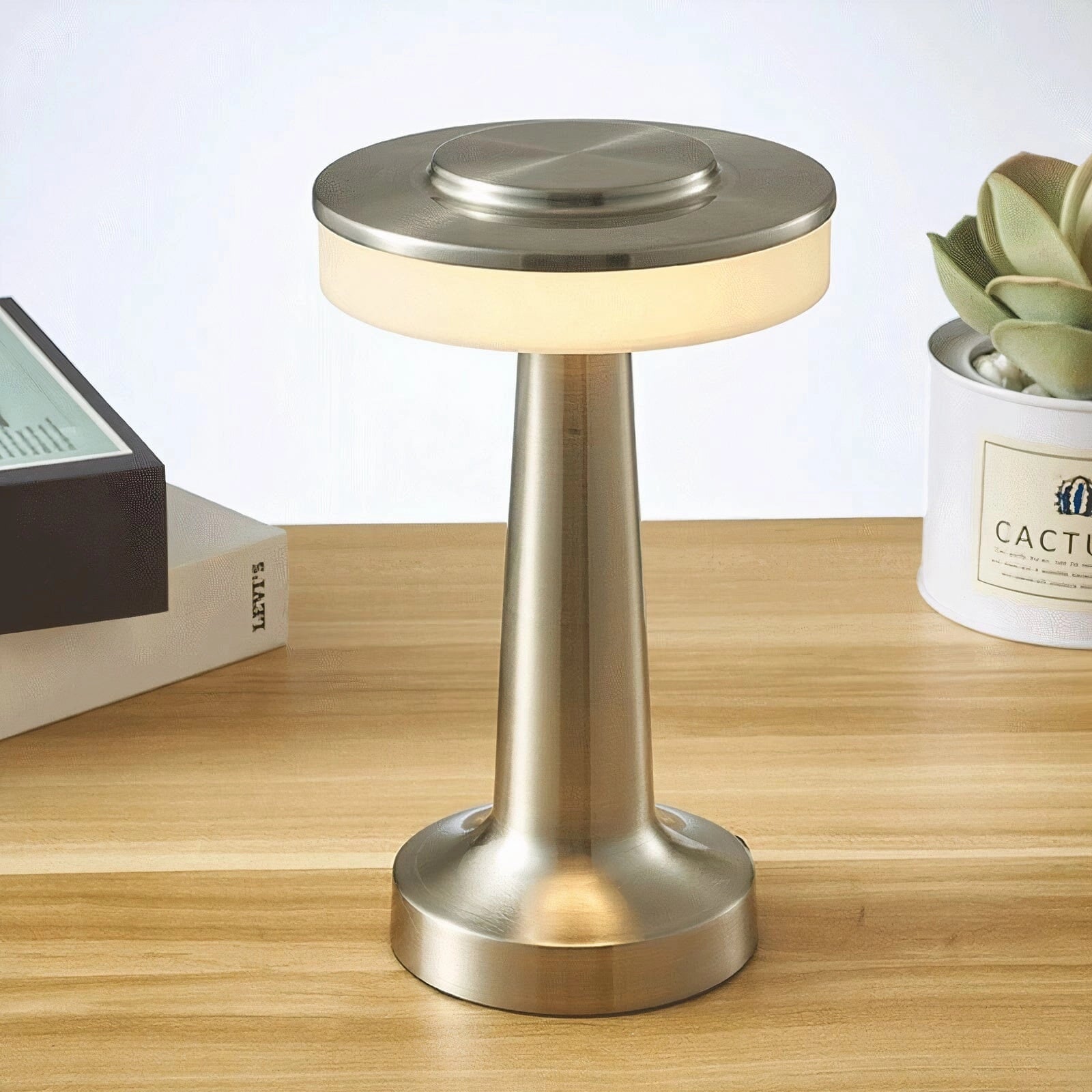 Luxury modern LED desk lamp with brass finish on a wooden desk, shown in silver variant, ideal for bedside and office use.