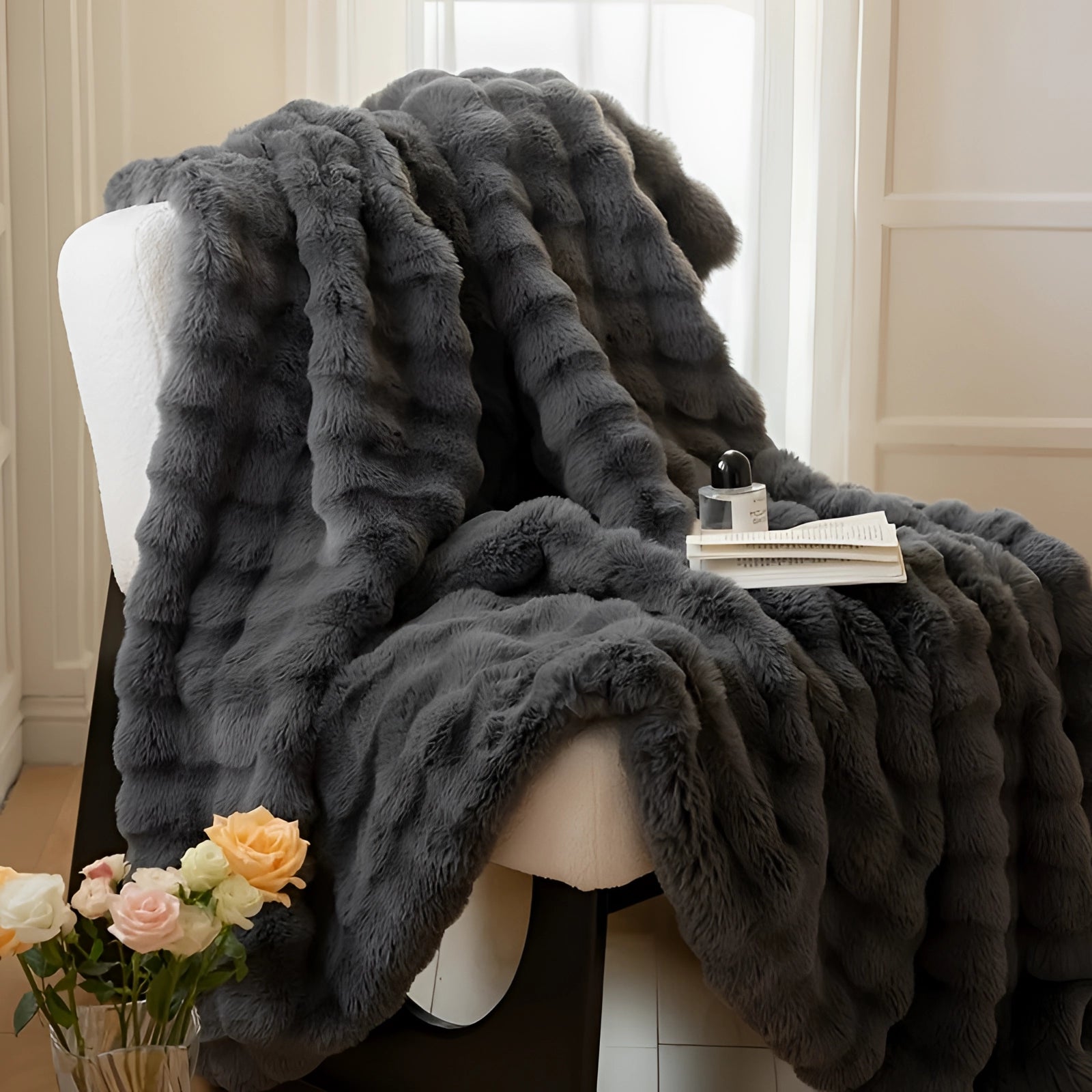 Luxurious oversized faux fur blanket in plush white, elegantly draped over a couch, providing a soft and comfortable touch to the decor.