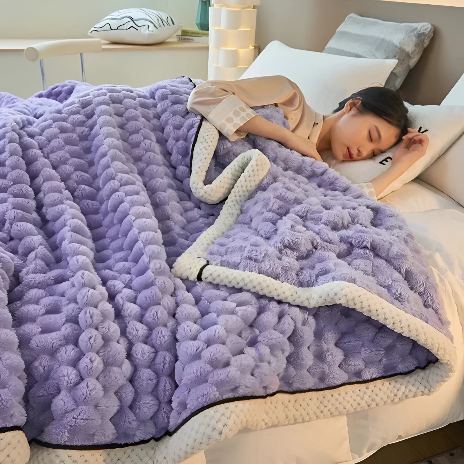 Luxurious purple comforter set with a plush, textured design, draped over a bed, adding elegance and comfort to bedroom decor.