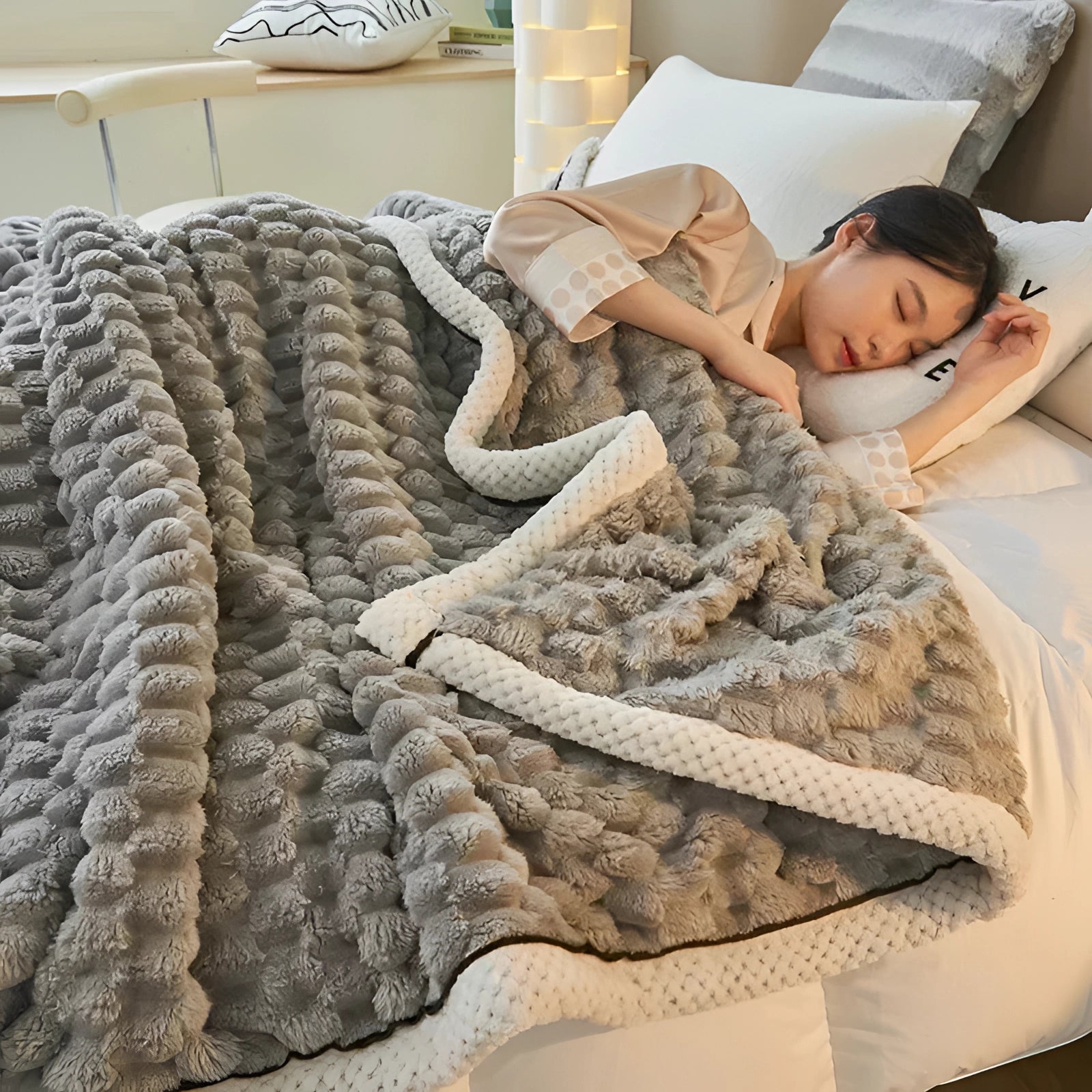 Plush gray comforter set with a textured design, styled on a wooden bed frame in a cozy bedroom setting, showcasing luxury bedding and home decor.