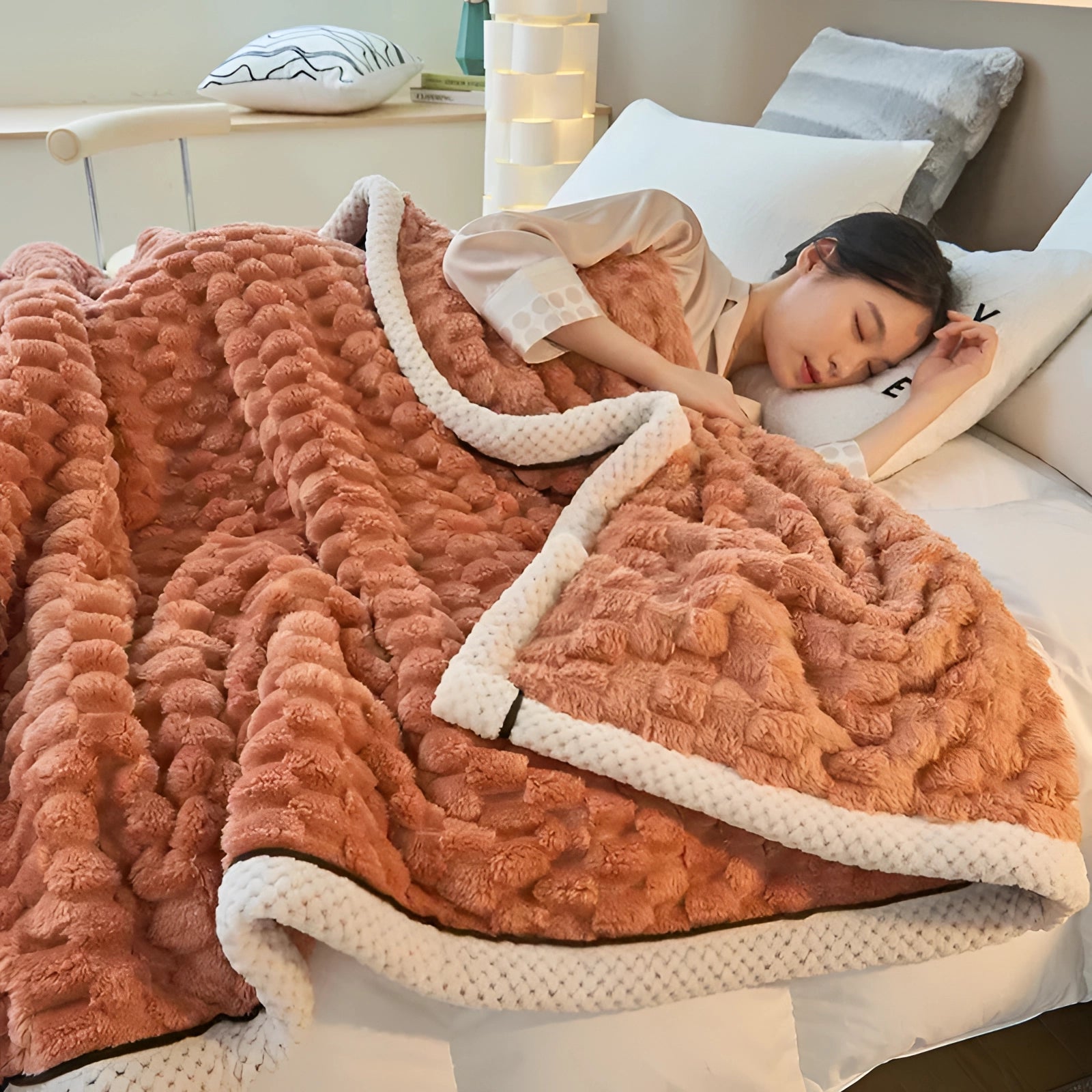 Luxury orange comforter set on a wooden floor, showcasing a plush textured design suitable for bedroom decor, with linens and bedding details visible.