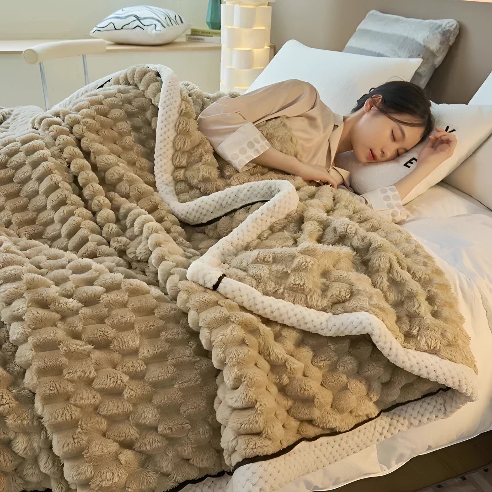 Brown plush textured comforter set on a couch with beige flooring and wood accents, featuring luxurious textile pattern and cozy bedding ideal for bedroom decor.