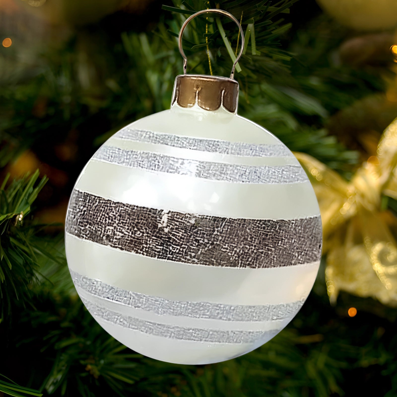 Luxury red plaid tartan glass Christmas ornament hanging on an evergreen Christmas tree, illuminated by soft lights, showcasing a unique holiday decoration.