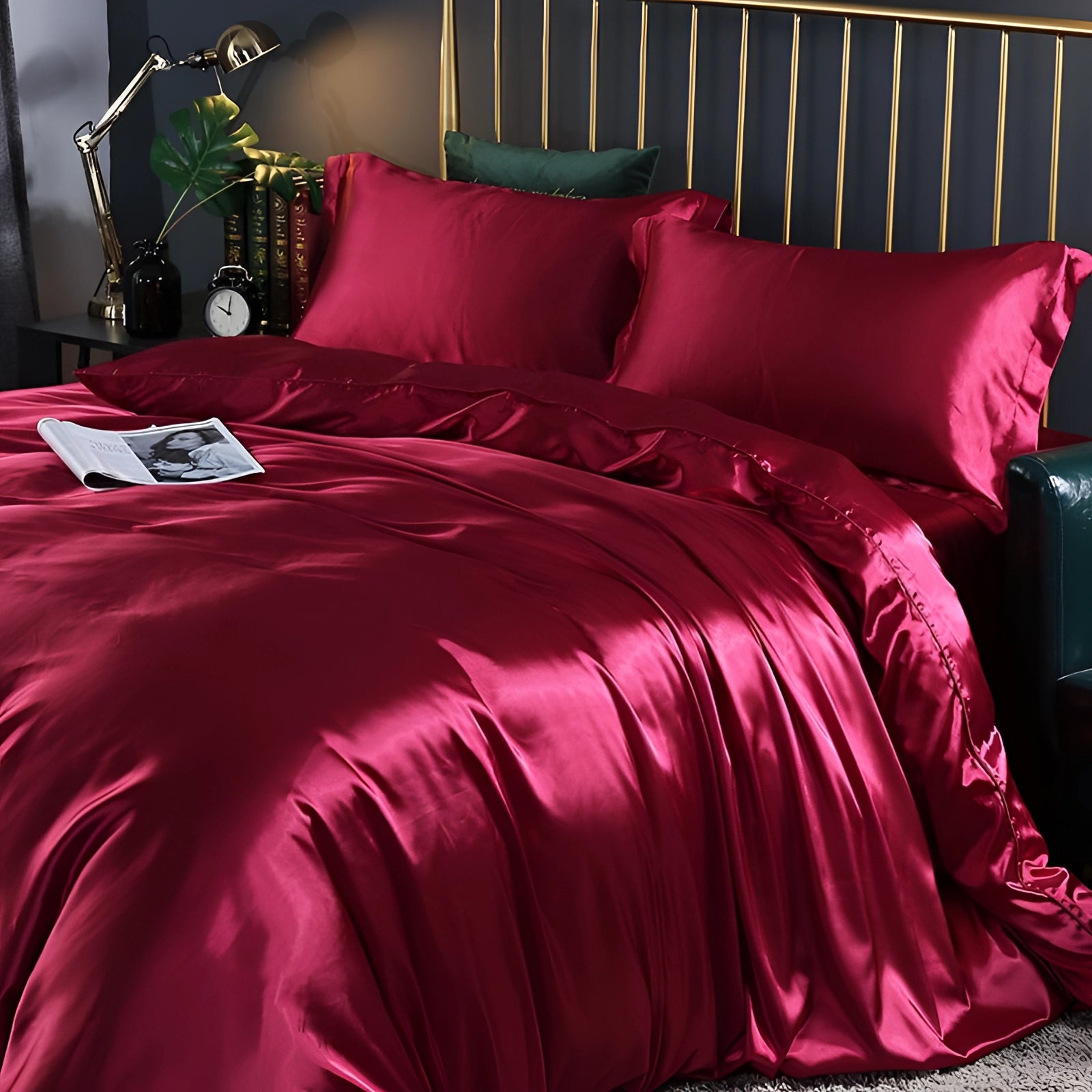 Luxury silk bedding set in red, fitted for a 180x200cm bed, shown in an elegantly furnished bedroom. The bedding is accompanied by matching pillows, creating a cozy and inviting atmosphere.