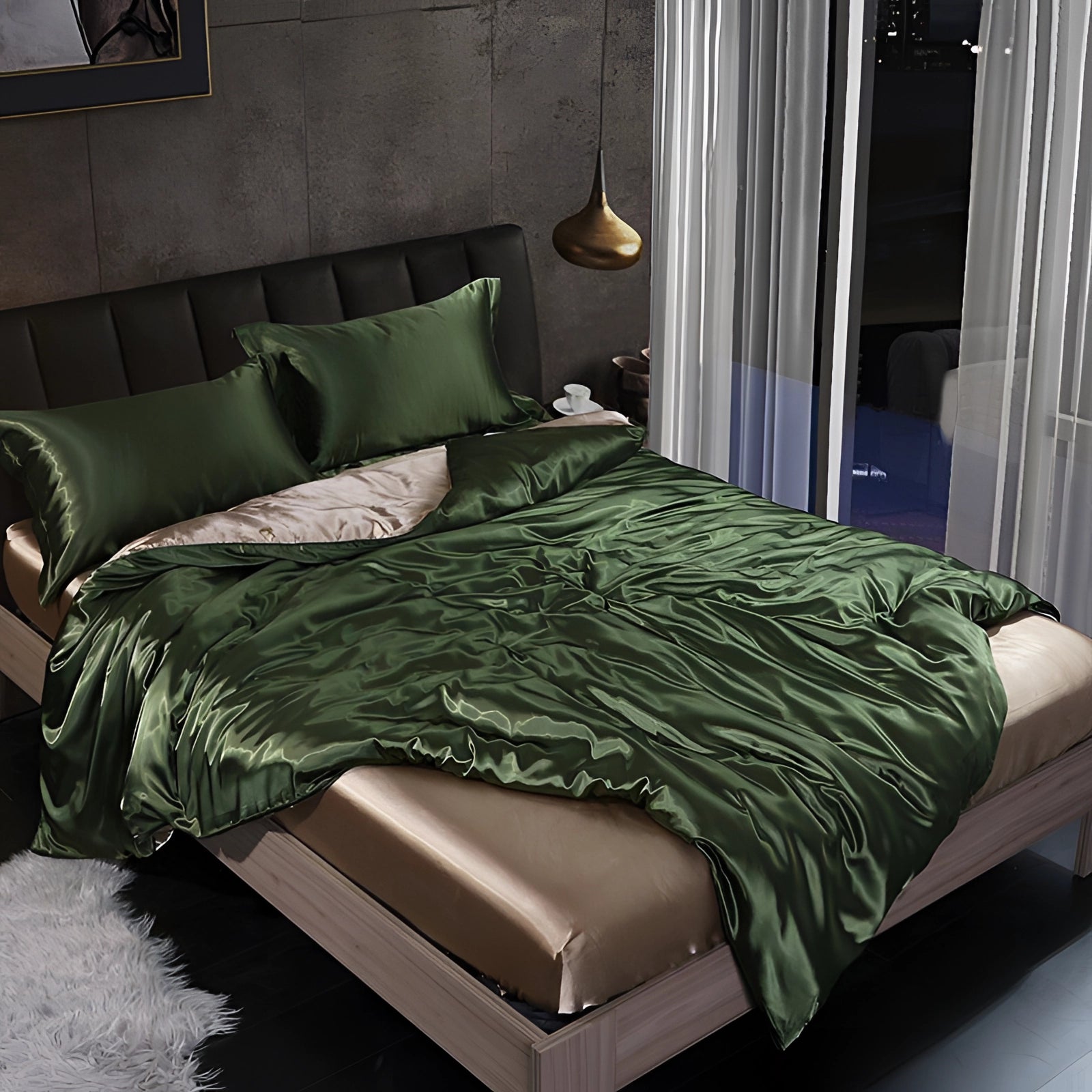 Luxury silk bedding set in army green, displayed in a tastefully designed bedroom with wooden furniture, featuring a fitted 180x200cm four-piece set that includes soft pillows and a sturdy bed frame, complemented by a stylish lamp and comfortable textiles.