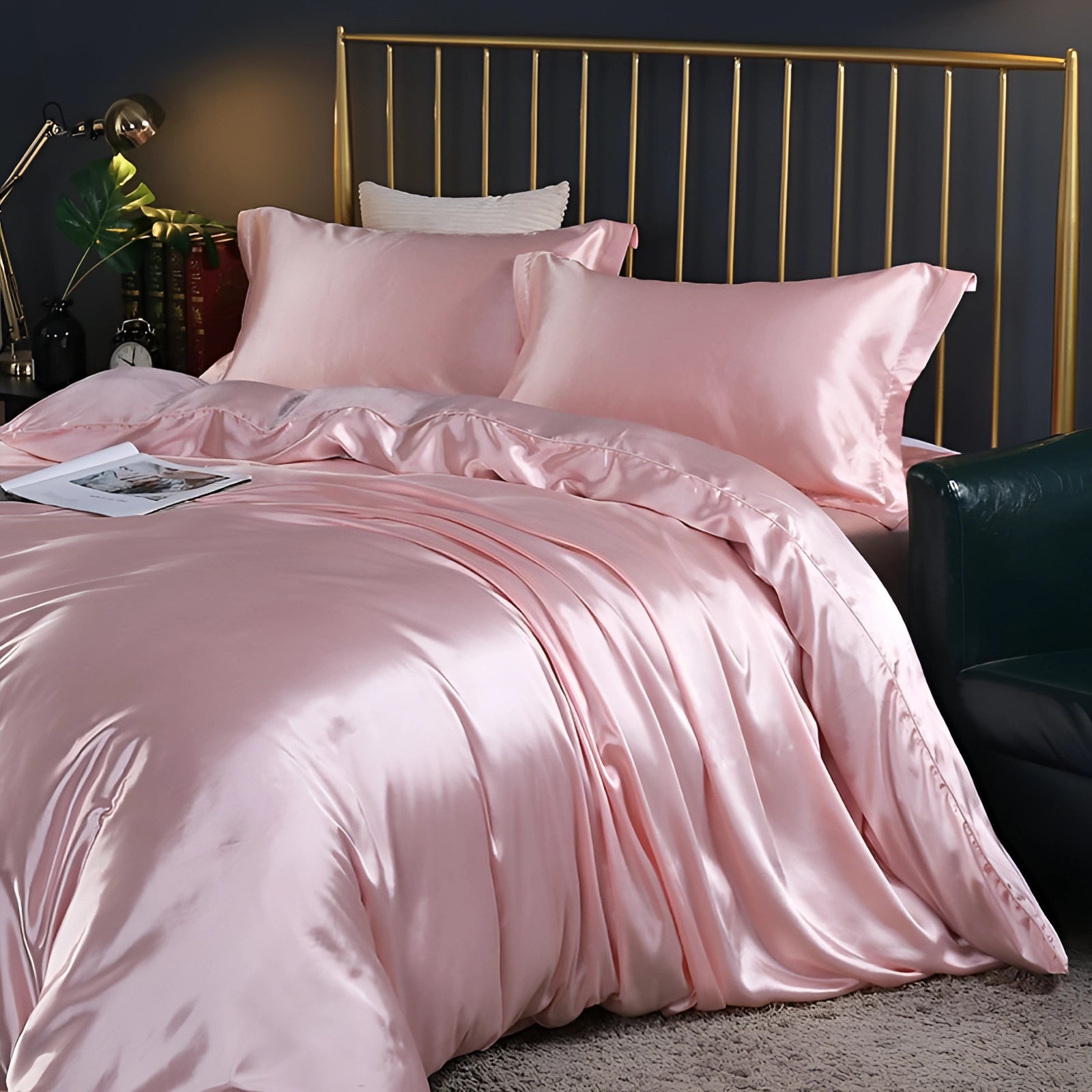 Luxury silk bedding set in pink, displayed on a 180x200cm fitted bed. The bedding set includes four pieces and is shown in a cozy interior setting with a hardwood floor and a wooden bed frame.