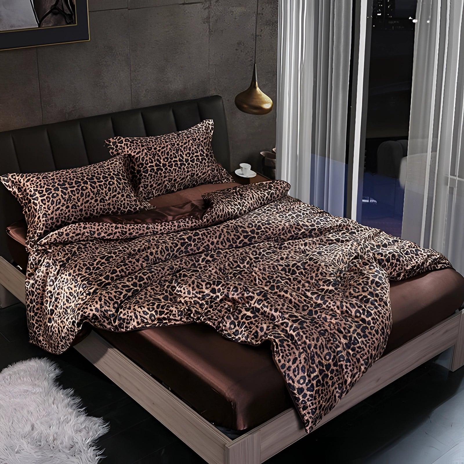 Luxury silk bedding set in a leopard print design on a fitted bed, featuring 180x200cm size with four pieces, including pillowcases, displayed on a wooden bed frame in a comfortable and stylish bedroom interior.
