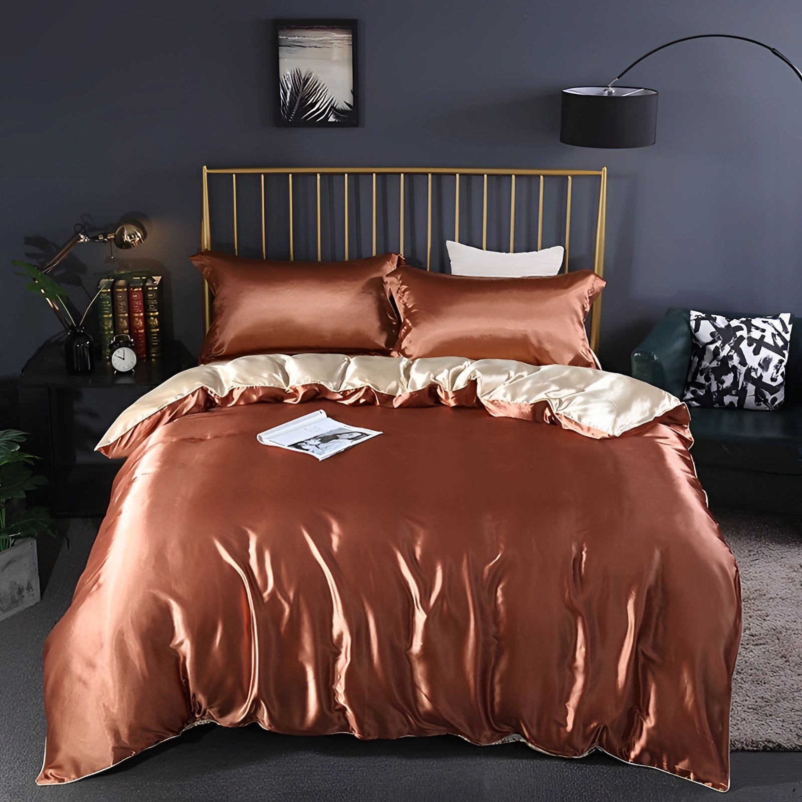 Luxury silk bedding set in metallic copper color displayed on a neatly made bed with a fitted sheet, in a stylishly designed bedroom featuring warm brown and wooden elements, soft lighting, and a comfortable ambiance.