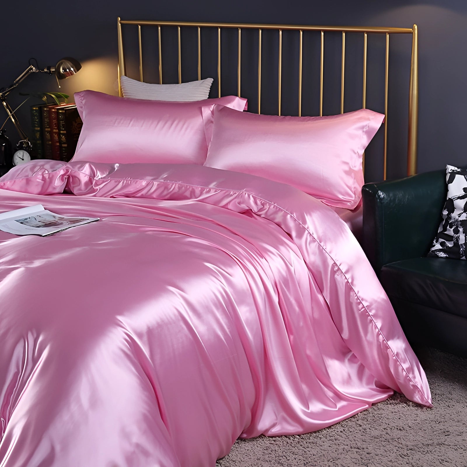 Light pink luxury silk bedding set displayed on a bed with a wooden floor, featuring a fitted sheet, pillowcases, and a duvet cover in a 180x200cm size.