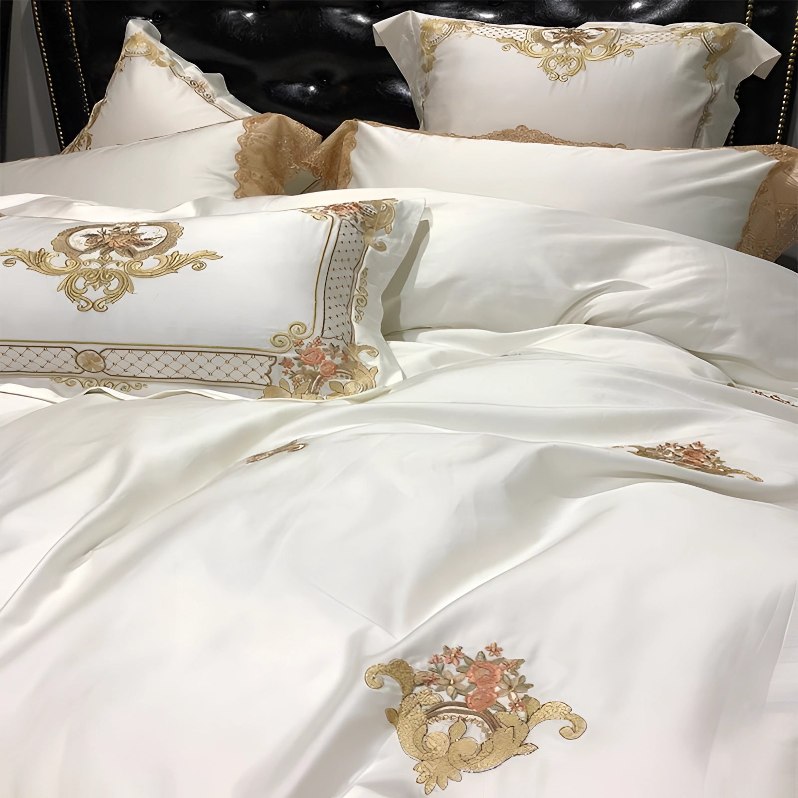 Luxury silk bedding set featuring a white duvet cover with elegant gold embroidery and matching pillowcases, showcasing intricate embellishments and patterns.