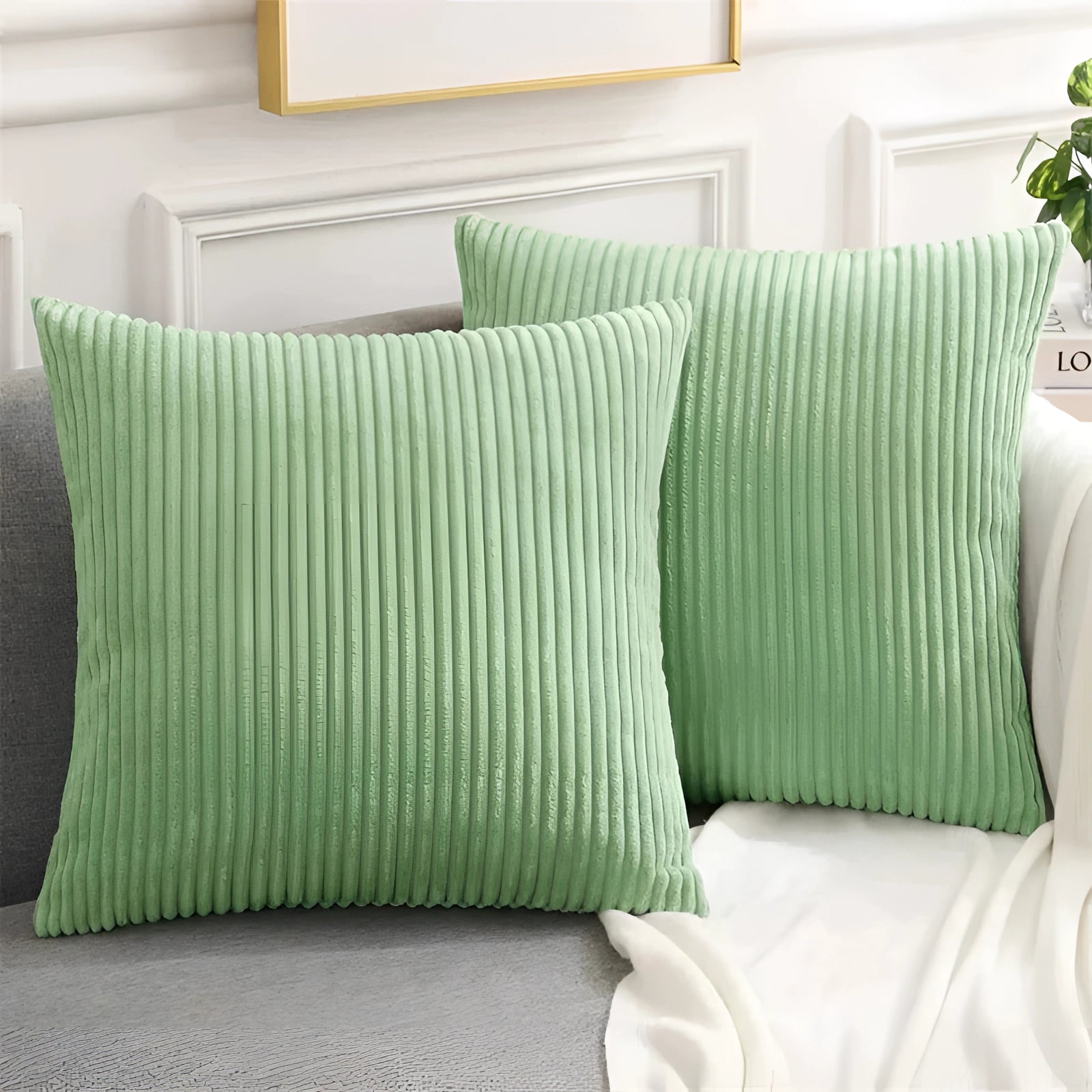 Sage green luxury soft corduroy cushion cover, measuring 50x50cm, displayed on a couch, highlighting its high-quality upholstery fabric and comfort.