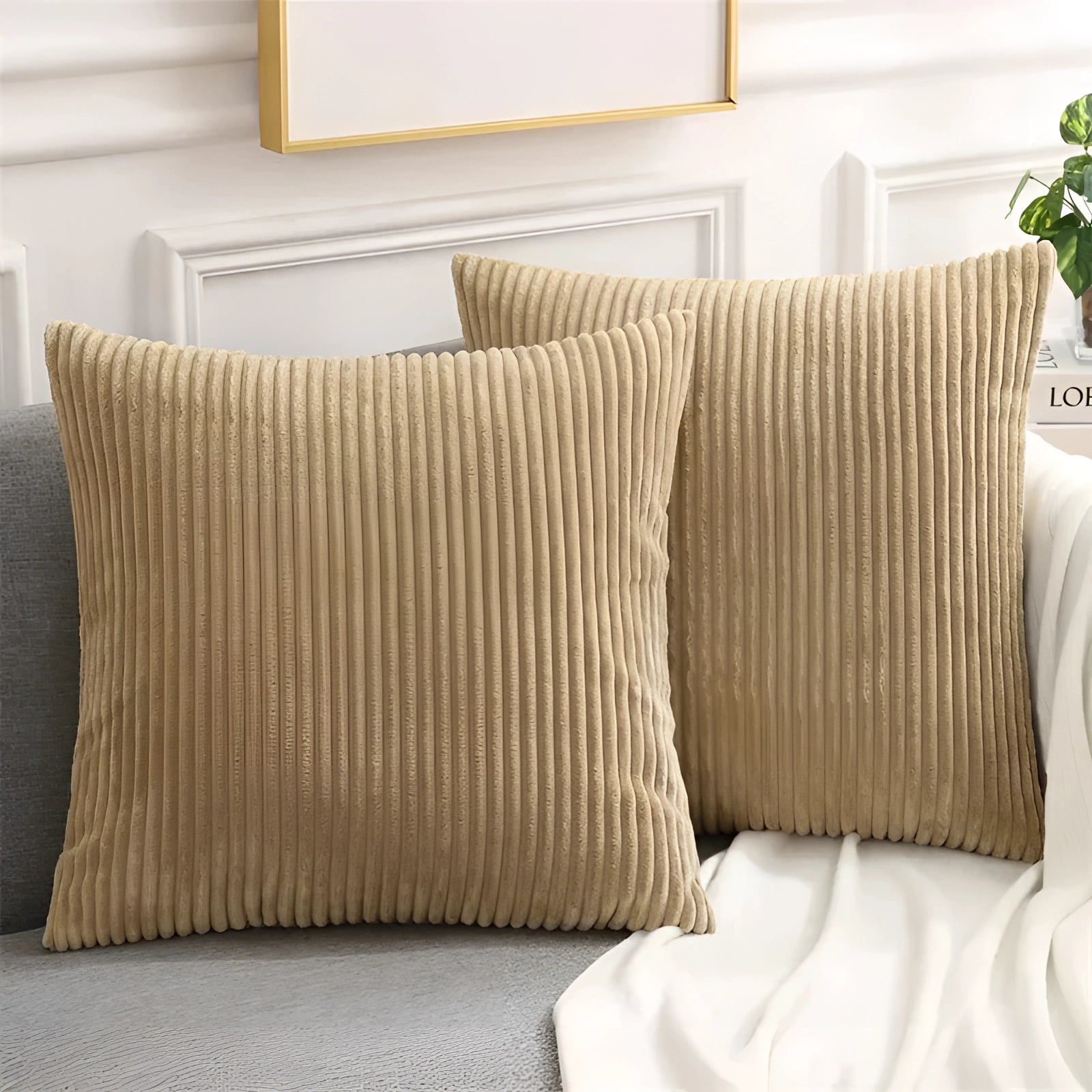 Luxury soft corduroy cushion cover in brown, measuring 50x50cm, displayed on a studio couch with wooden elements and a plant nearby, highlighting its high-quality upholstery fabric and comfort.