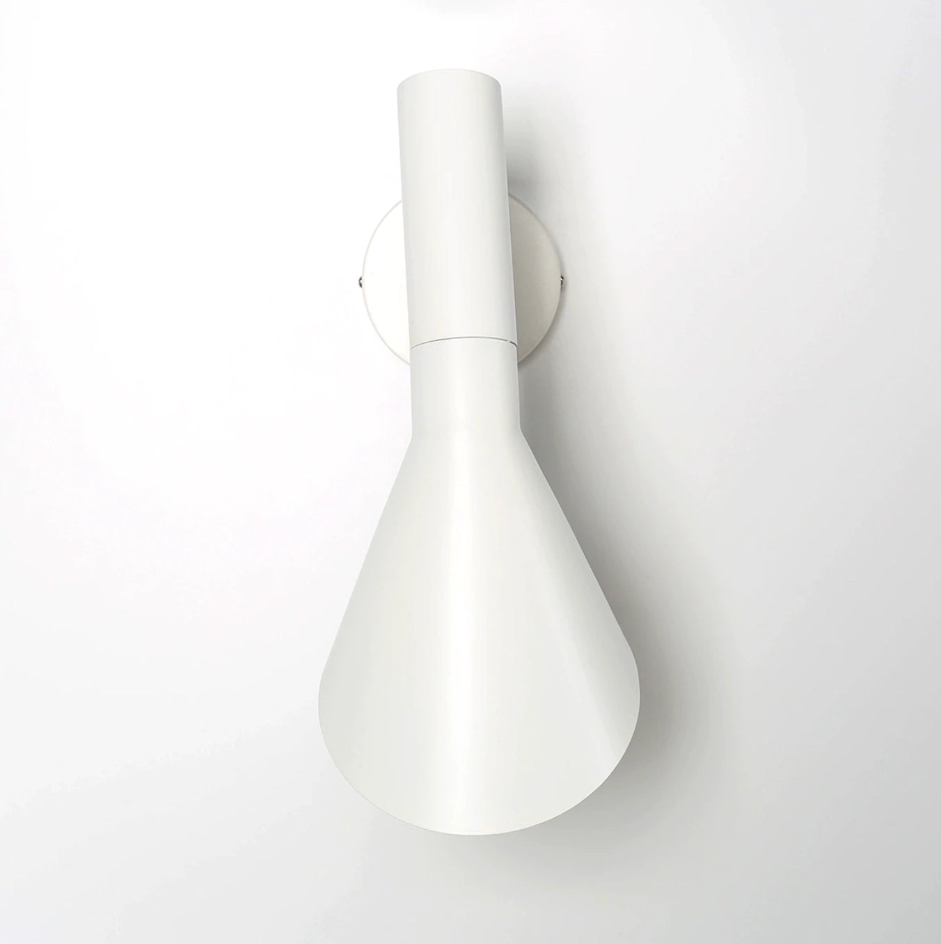 Matte black adjustable LED wall lamp with a modern sconce design, featuring a circular metal build, suitable for bedroom lighting.