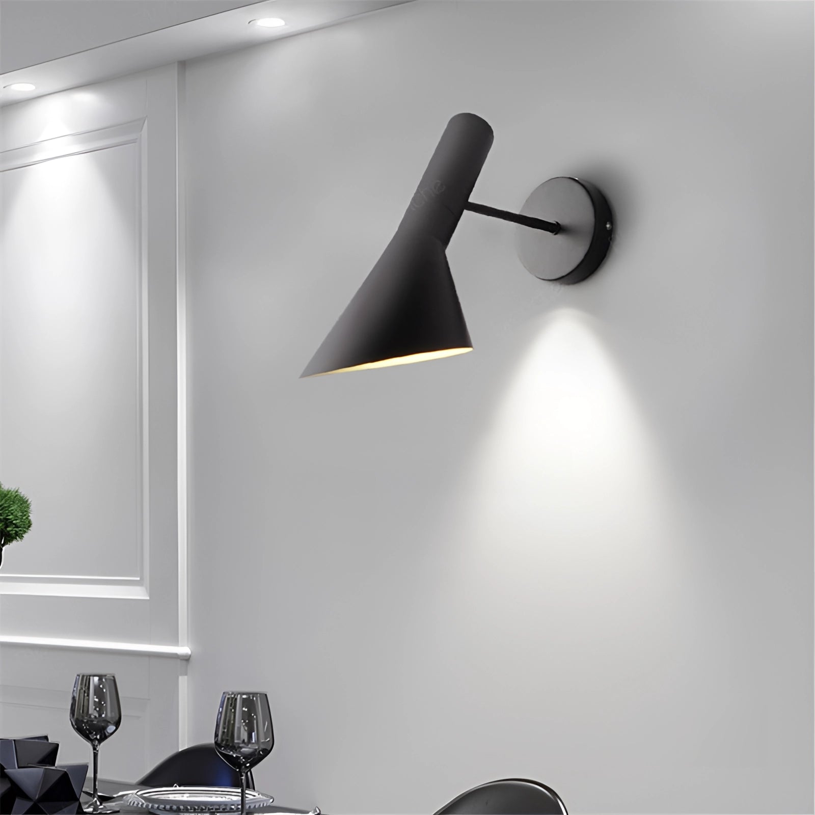 Matte black adjustable LED wall lamp mounted on a wall in a modern bedroom setting, featuring sleek design elements with a focus on interior lighting.
