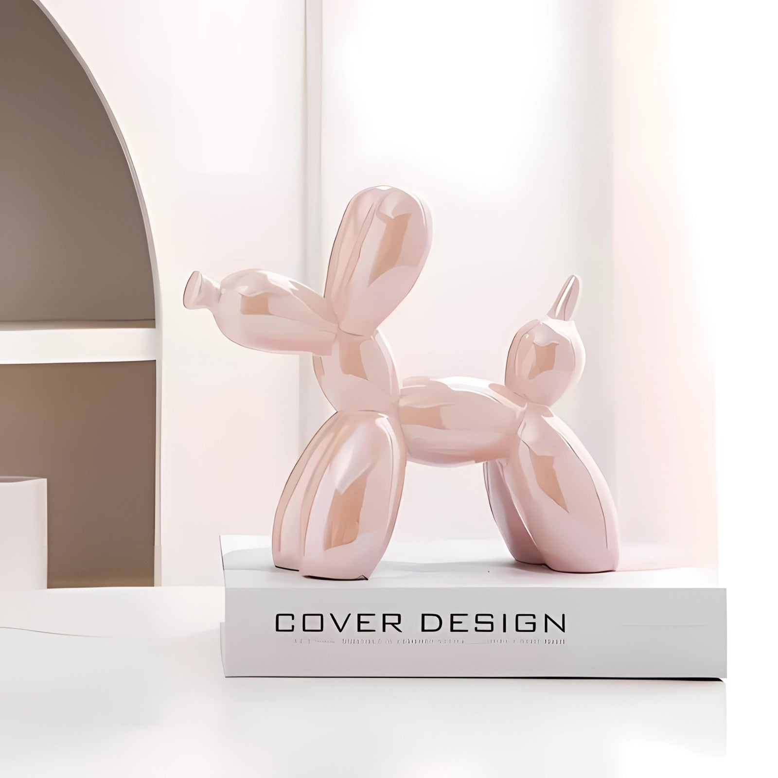 Pink metallic balloon dog sculpture displayed as modern art decor with a luxurious finish, set against a neutral background.