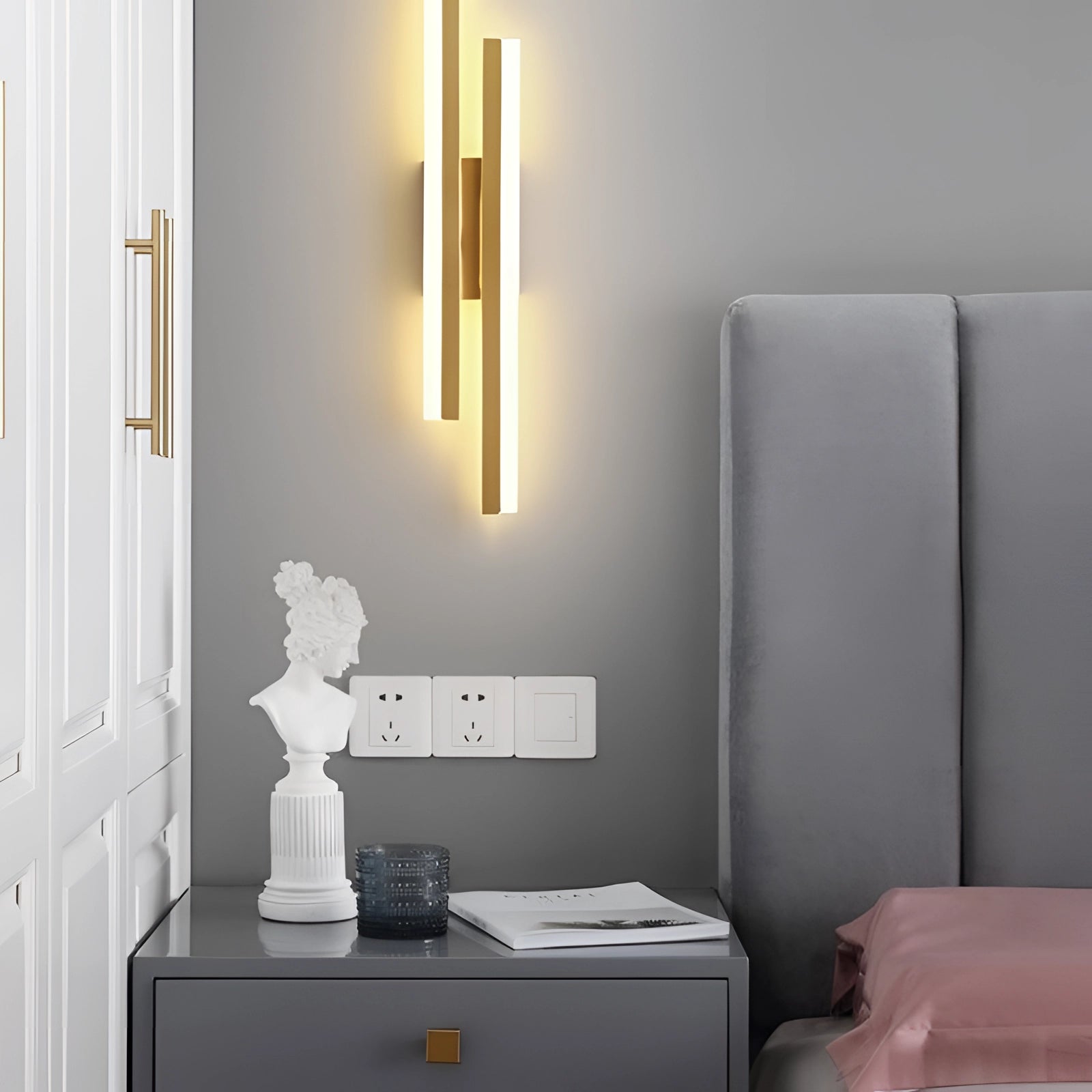 Minimalist black and white vertical line art displayed on a wall in a modern interior space with neutral tones, featuring a wooden table and grey floor.
