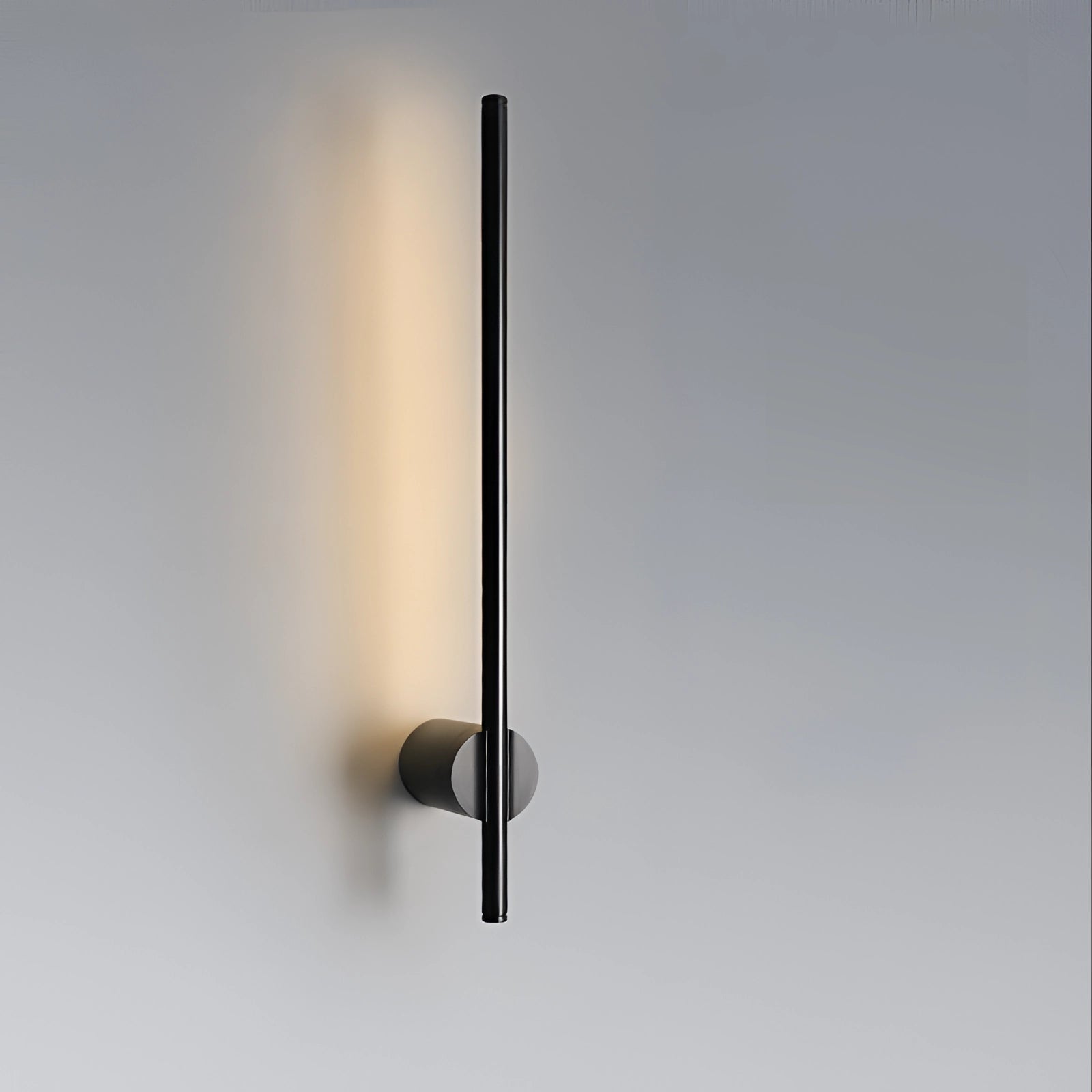 Minimalist LED wall sconce in a sleek vertical design with a modern rectangular shape, made of metal and emitting soft light.