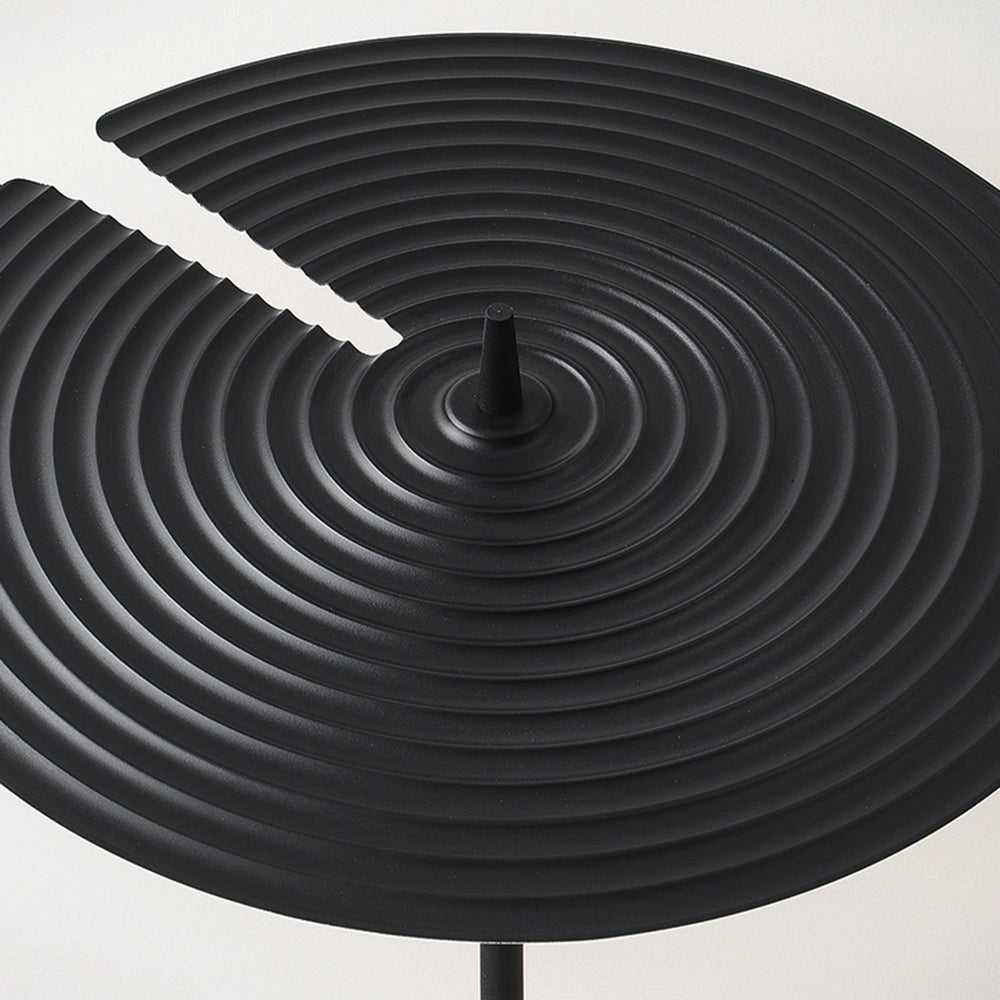 Minimalist matte black floor lamp with a sleek design featuring an adjustable arm and round base made from metal, set against a monochrome background.