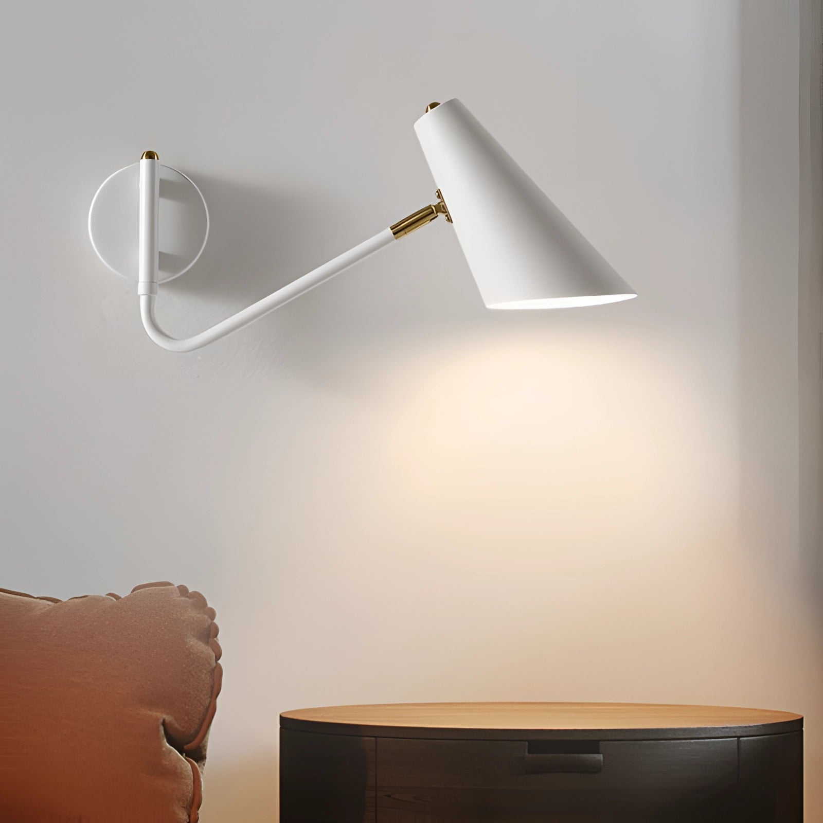 Modern white adjustable wall sconce with a minimalist industrial design, featuring a sleek rectangular shape mounted on a wooden panel against a white wall.