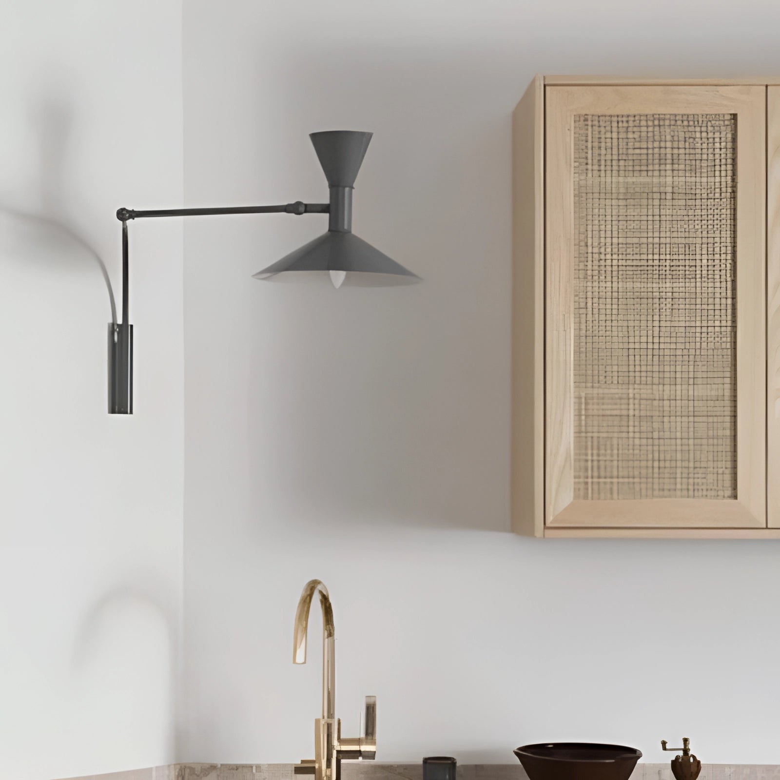 Modern black geometric wall sconce mounted on a grey wall, featuring a contemporary minimalist design with a rectangular shape, enhancing the interior design of the space with its sleek and stylish appearance.