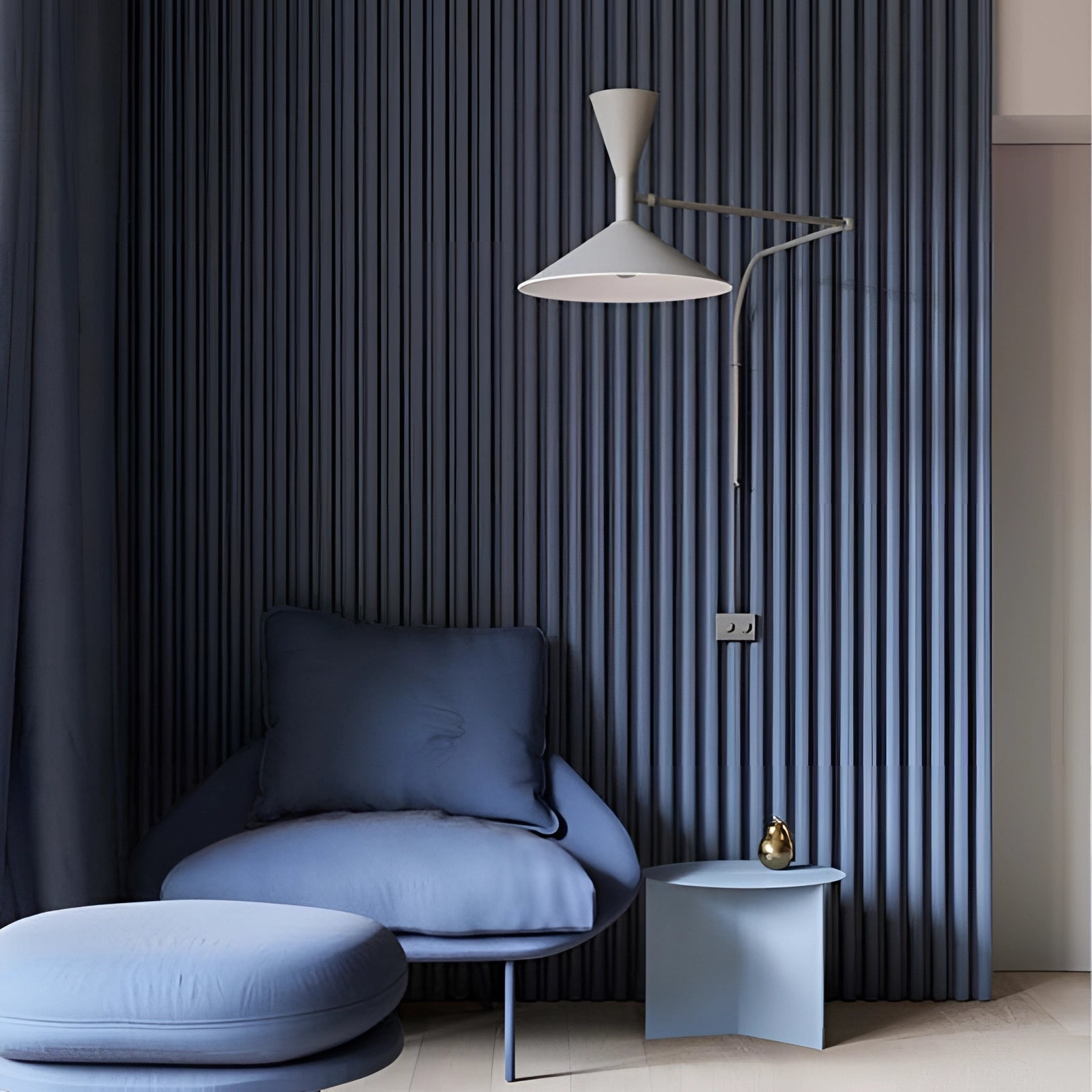 Modern black geometric wall sconce installed on a white interior wall, showcasing its contemporary minimalist design and providing sleek architectural lighting.