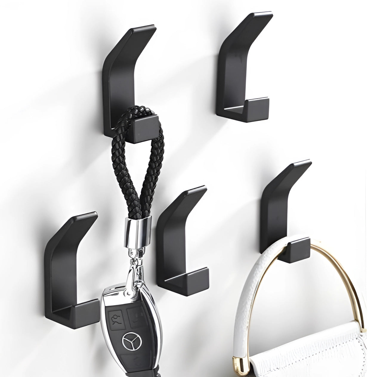 Black metal wall hooks with a modern minimalist design, suitable for home decor and organization.