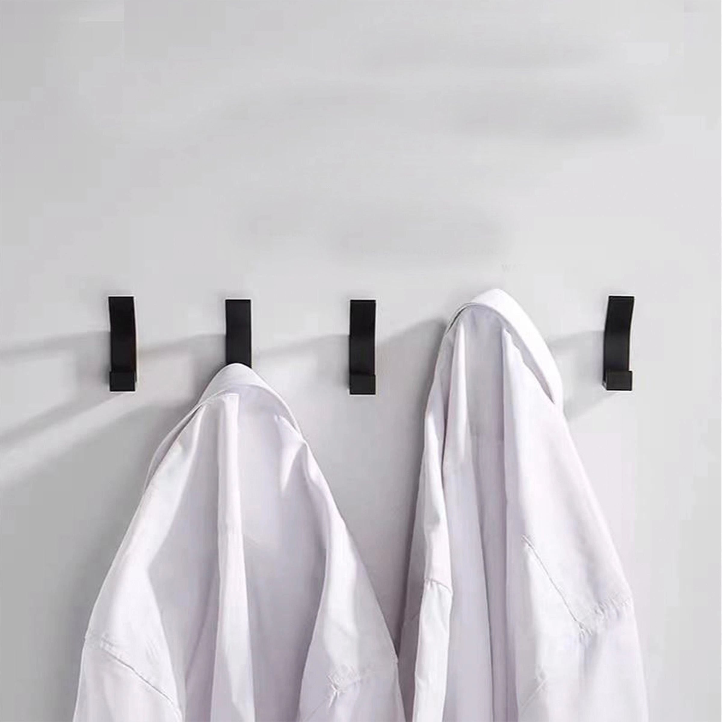 Minimalist black metal wall hooks with a sleek and stylish design, suitable for modern home decor and organization.