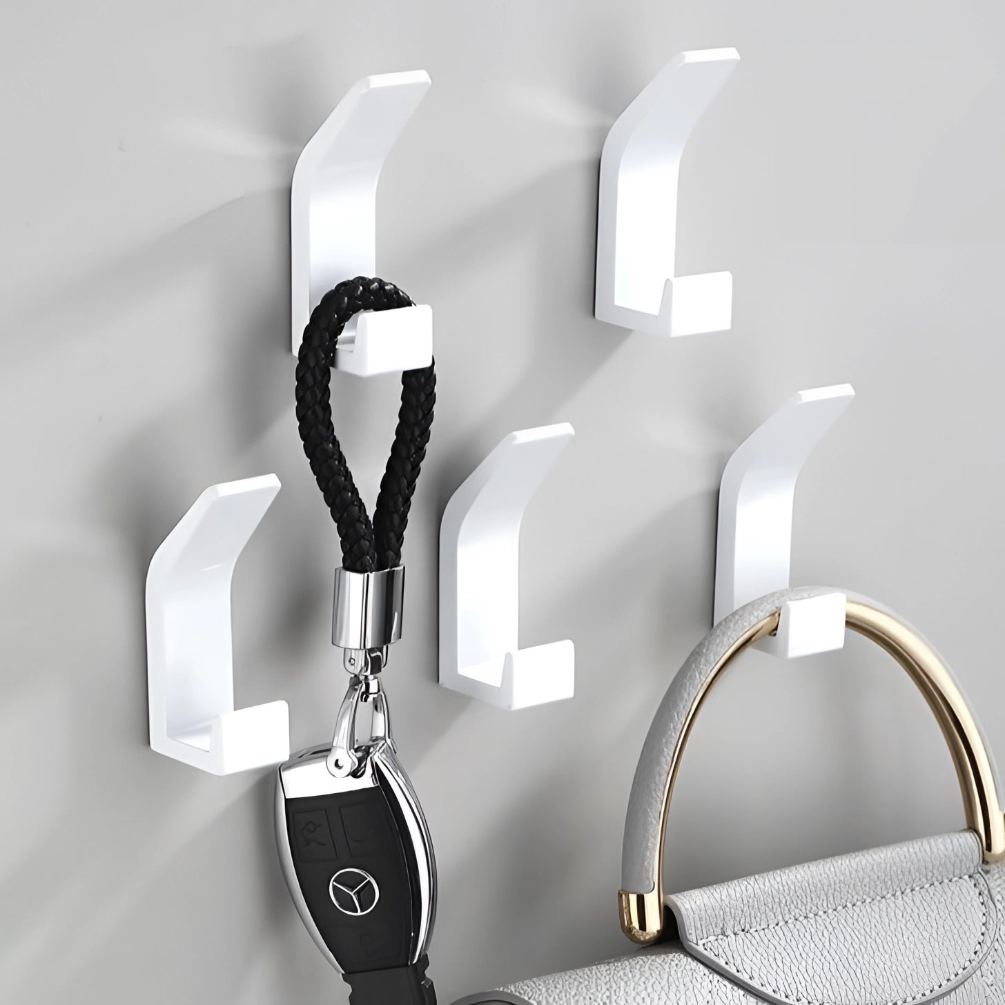 Modern black metal wall hooks mounted on a light-colored wall, showcasing a sleek and minimalist design ideal for stylish home decor.